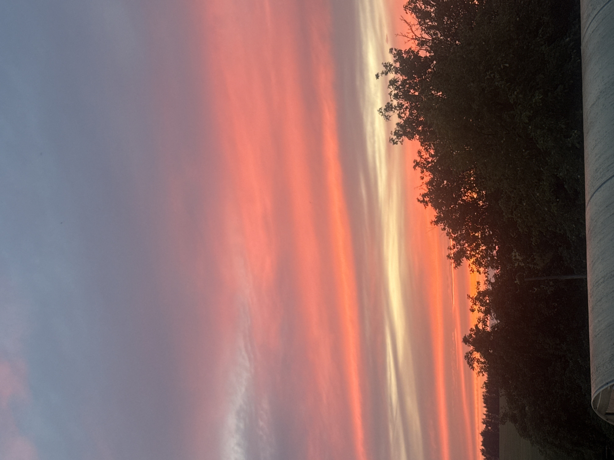 Vivid pink and orange sunset sky over Alexandrovka, Russia.