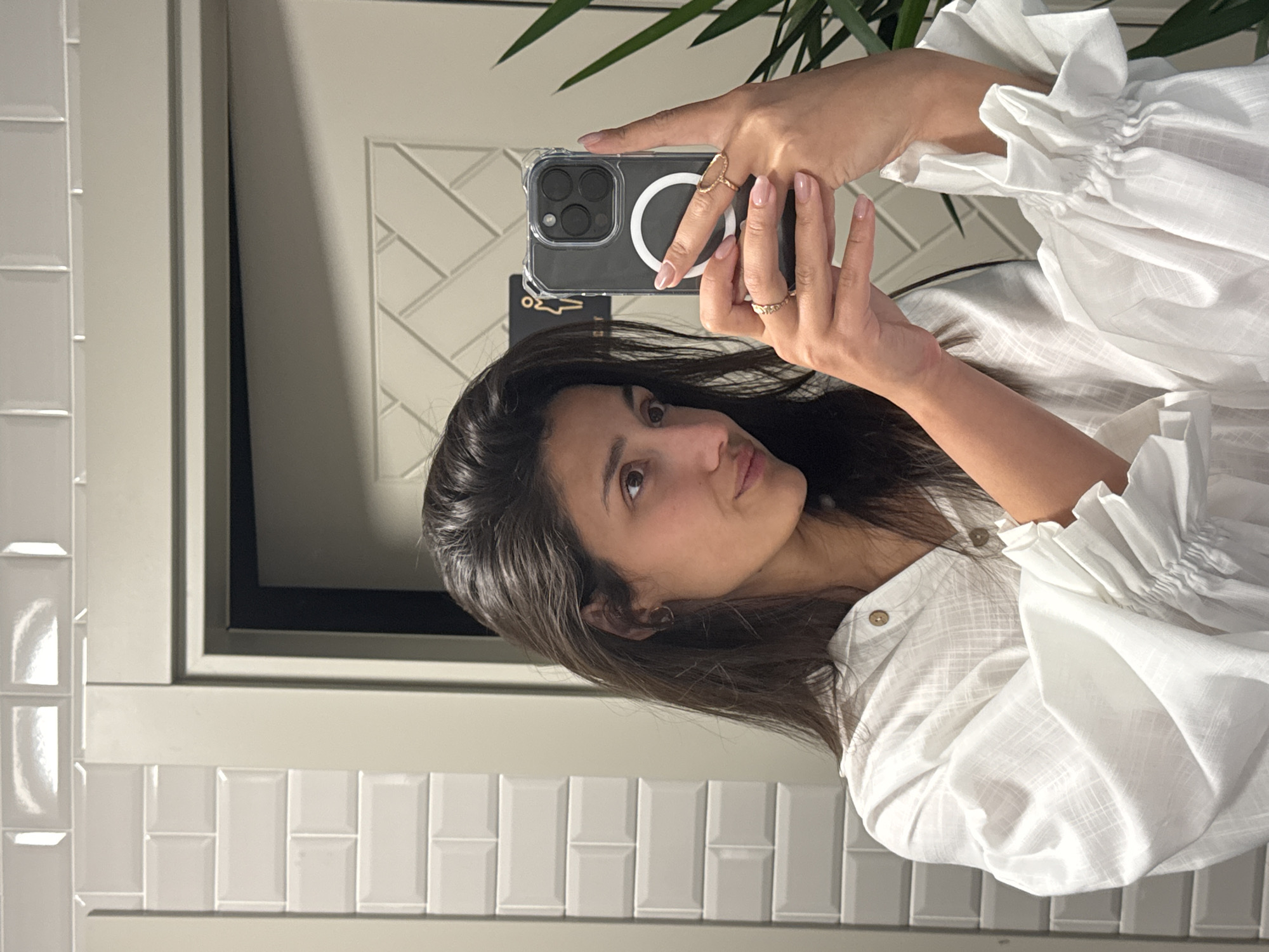 Woman takes mirror selfies in Montenegro restroom