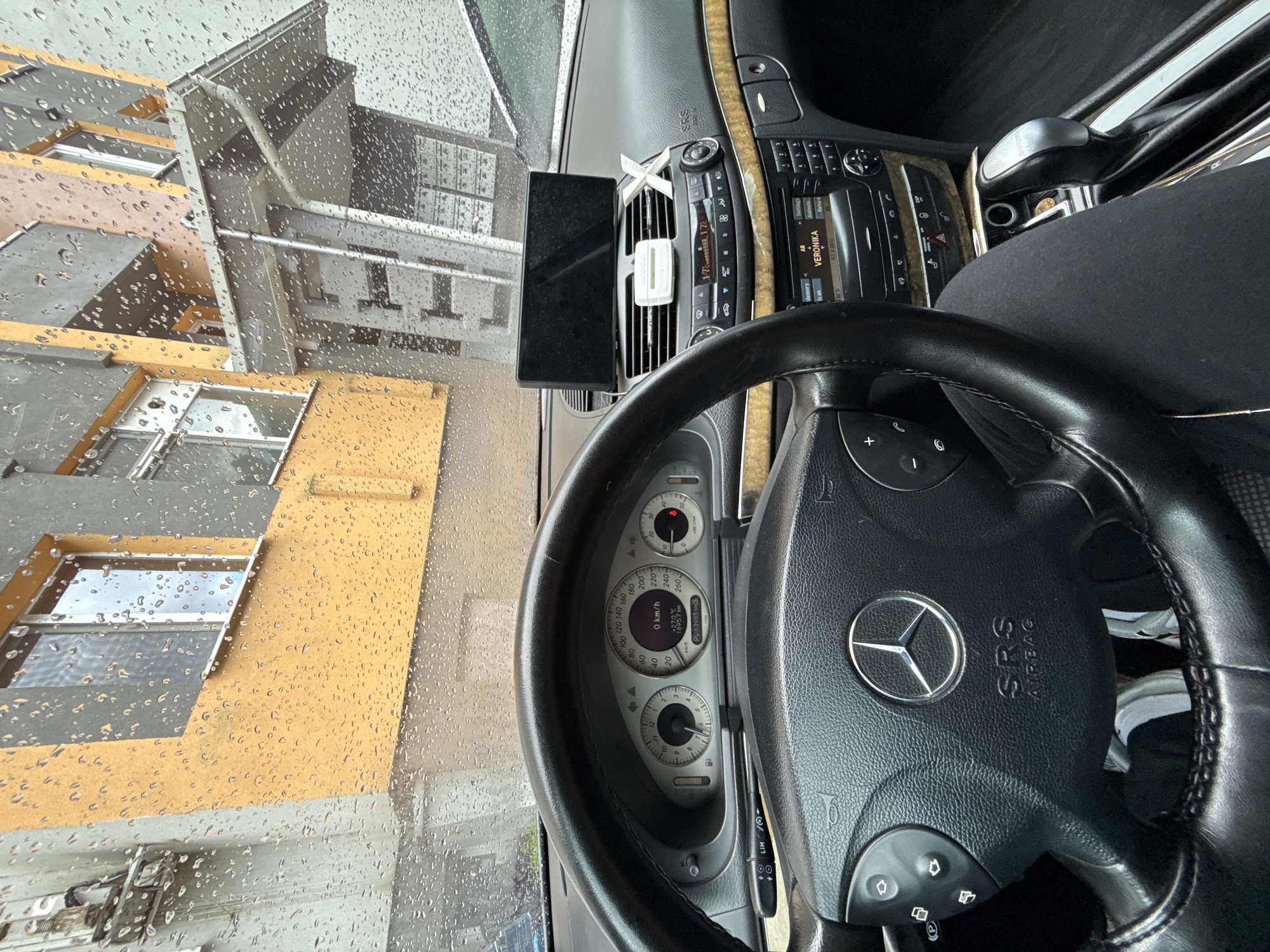 Man takes selfies in parked Mercedes during rain in Bulgaria