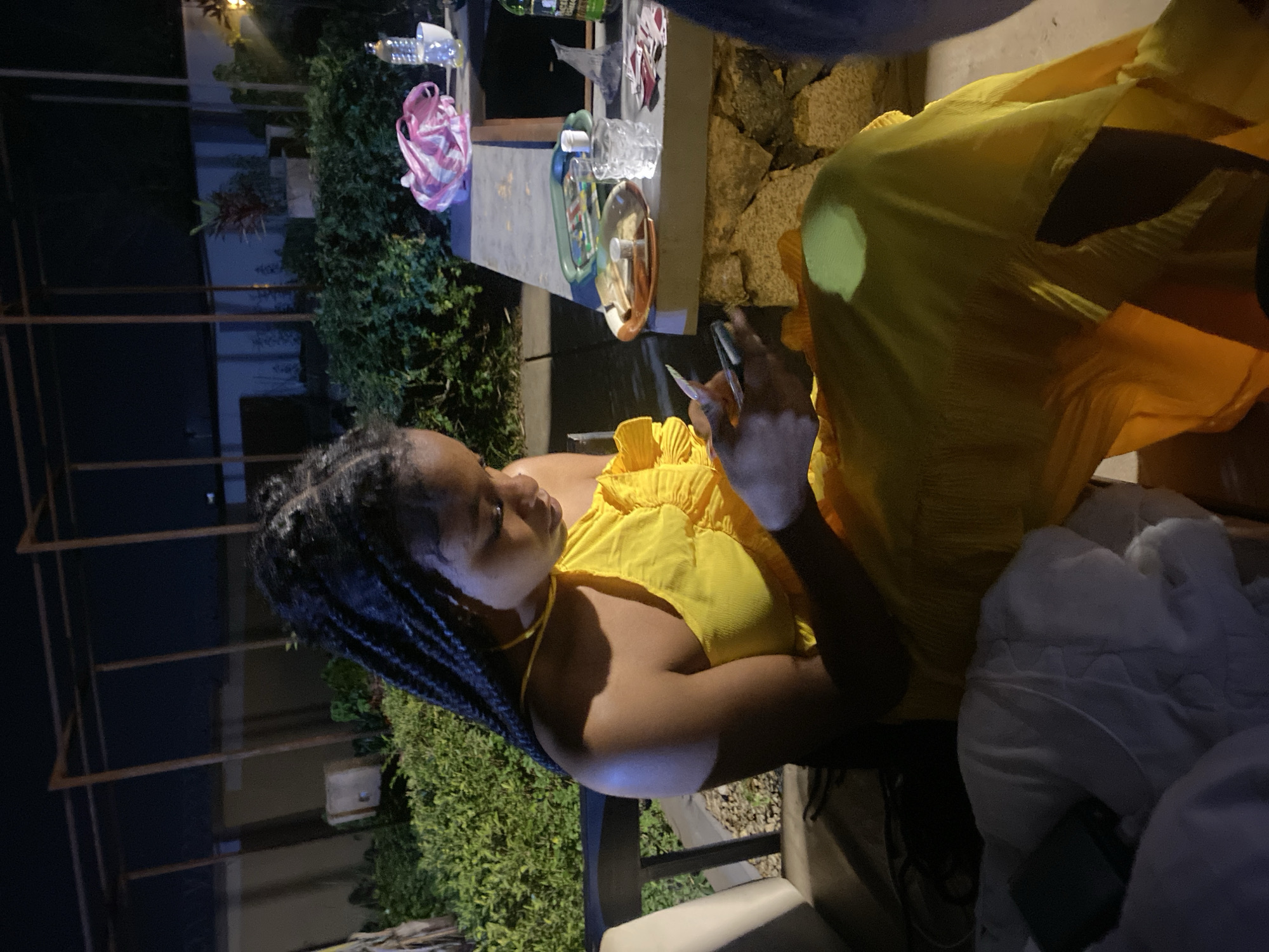 Casual nighttime hangout in Jos, Nigeria, phones out
