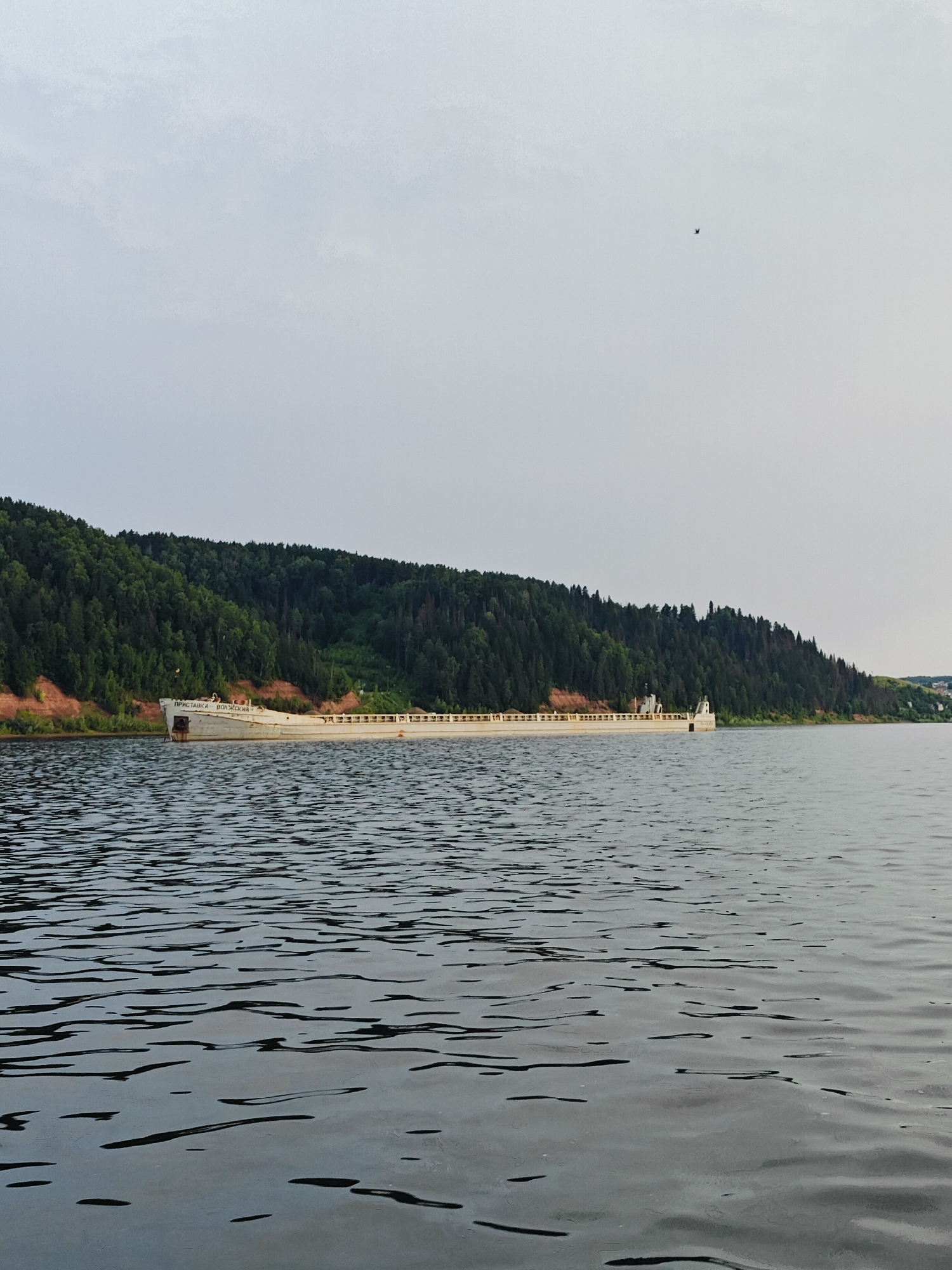 White barge and infrastructure along the Kama River, Russia