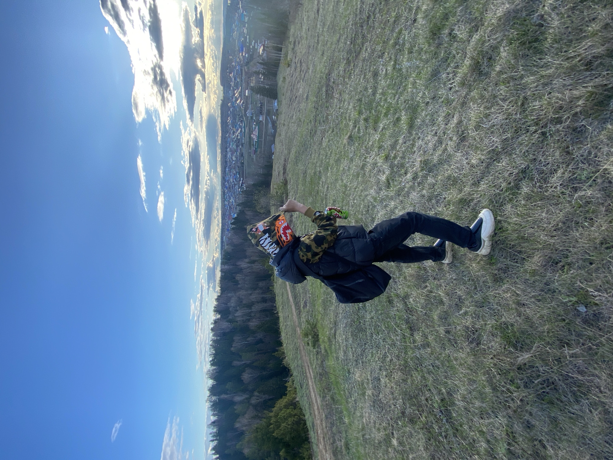 Person observed on hillside overlooking town during afternoon hours