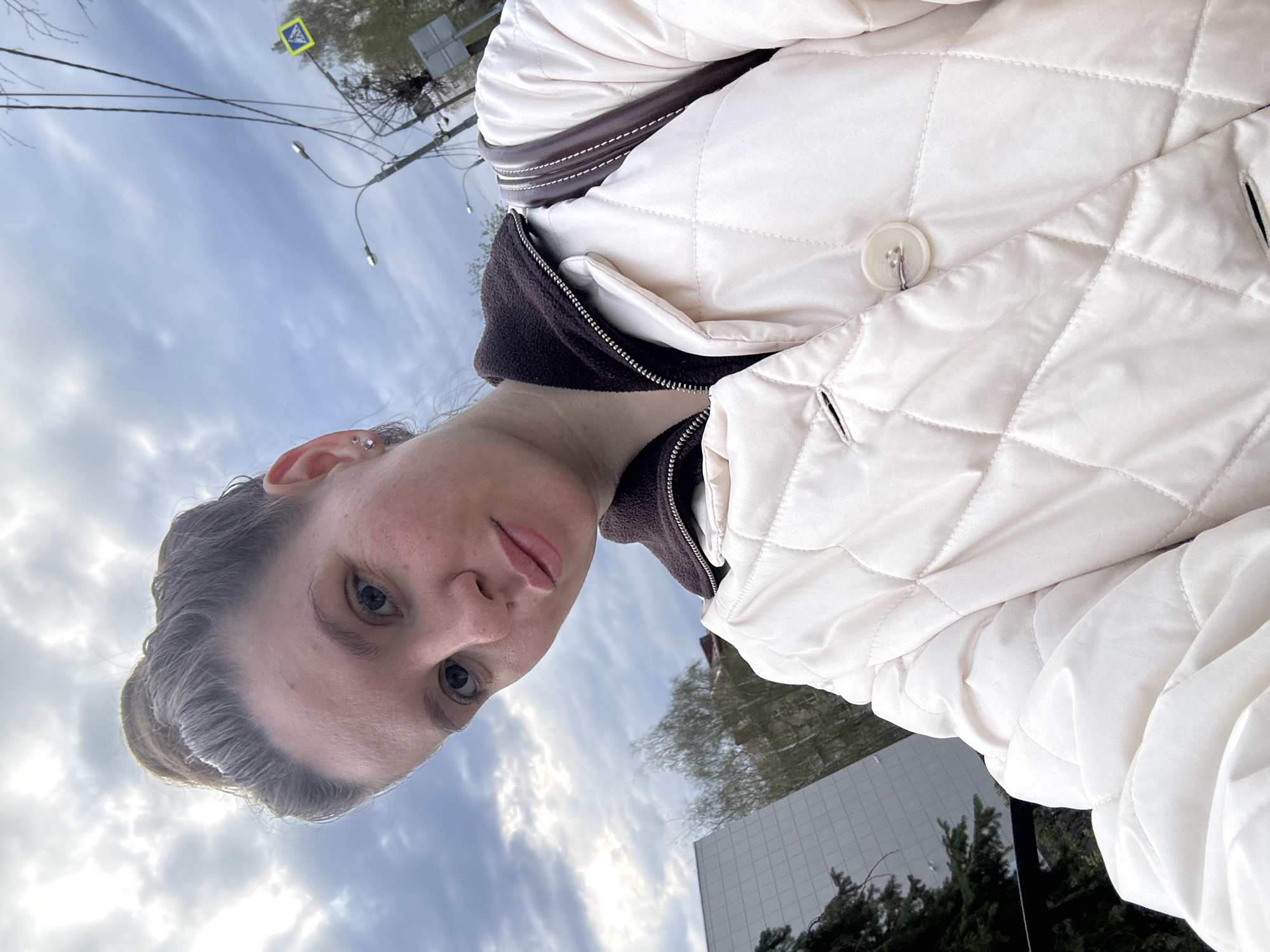 Woman takes selfie in quilted jacket in Klin, Russia