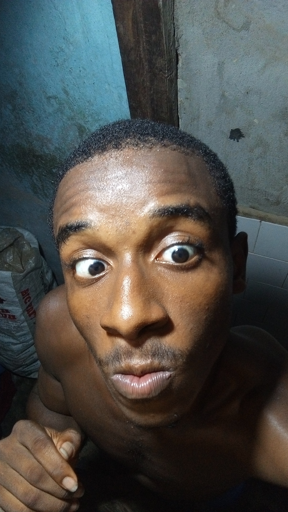 Man captures series of expressive selfies indoors