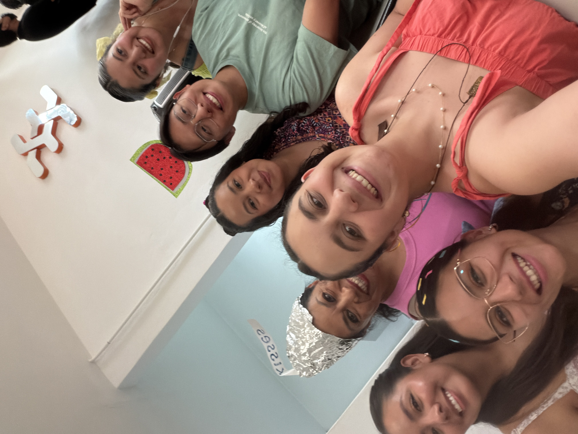 Young women gather for group photo with novelty decoration