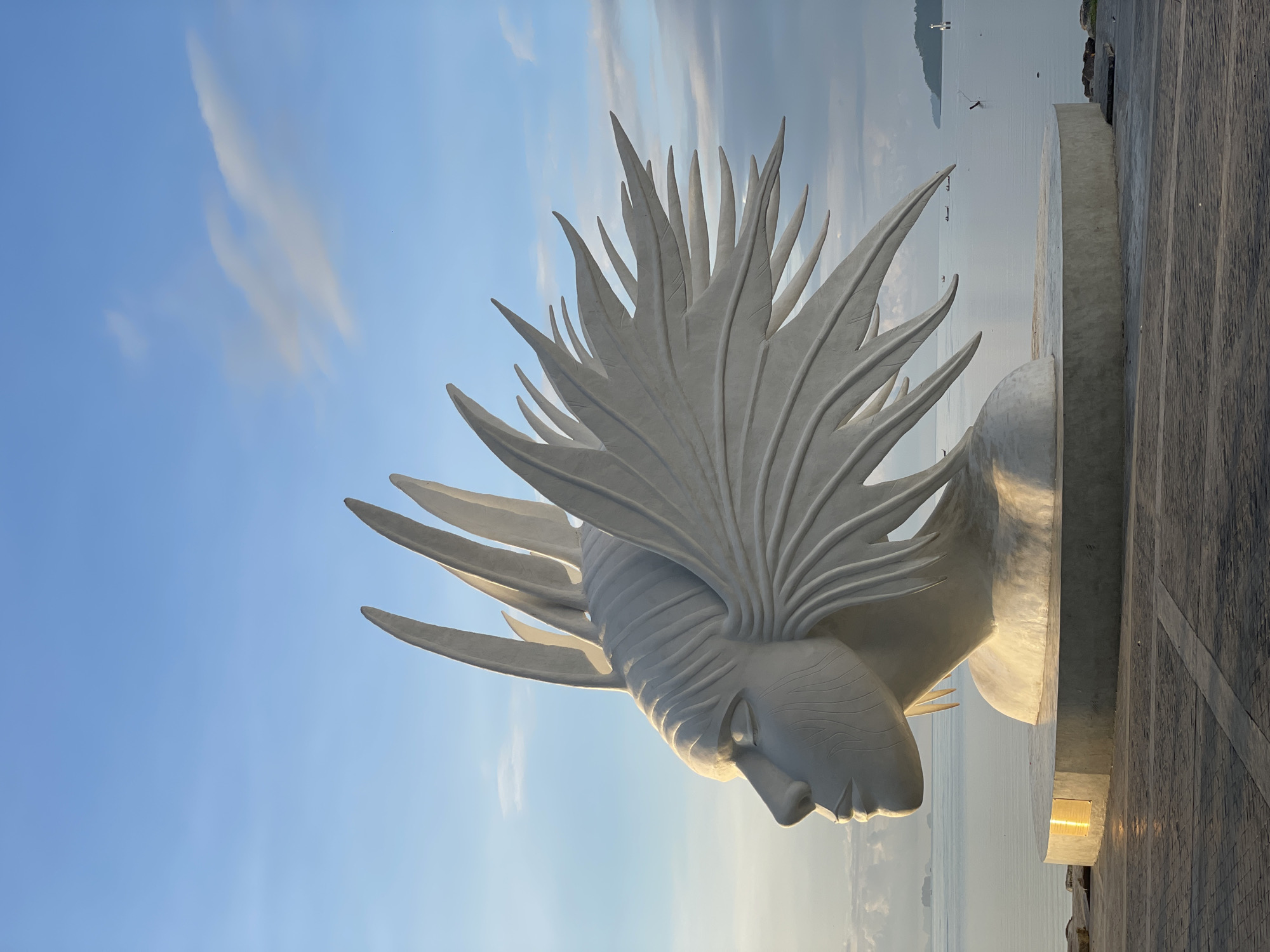 White abstract head sculpture on Phuket's seaside promenade