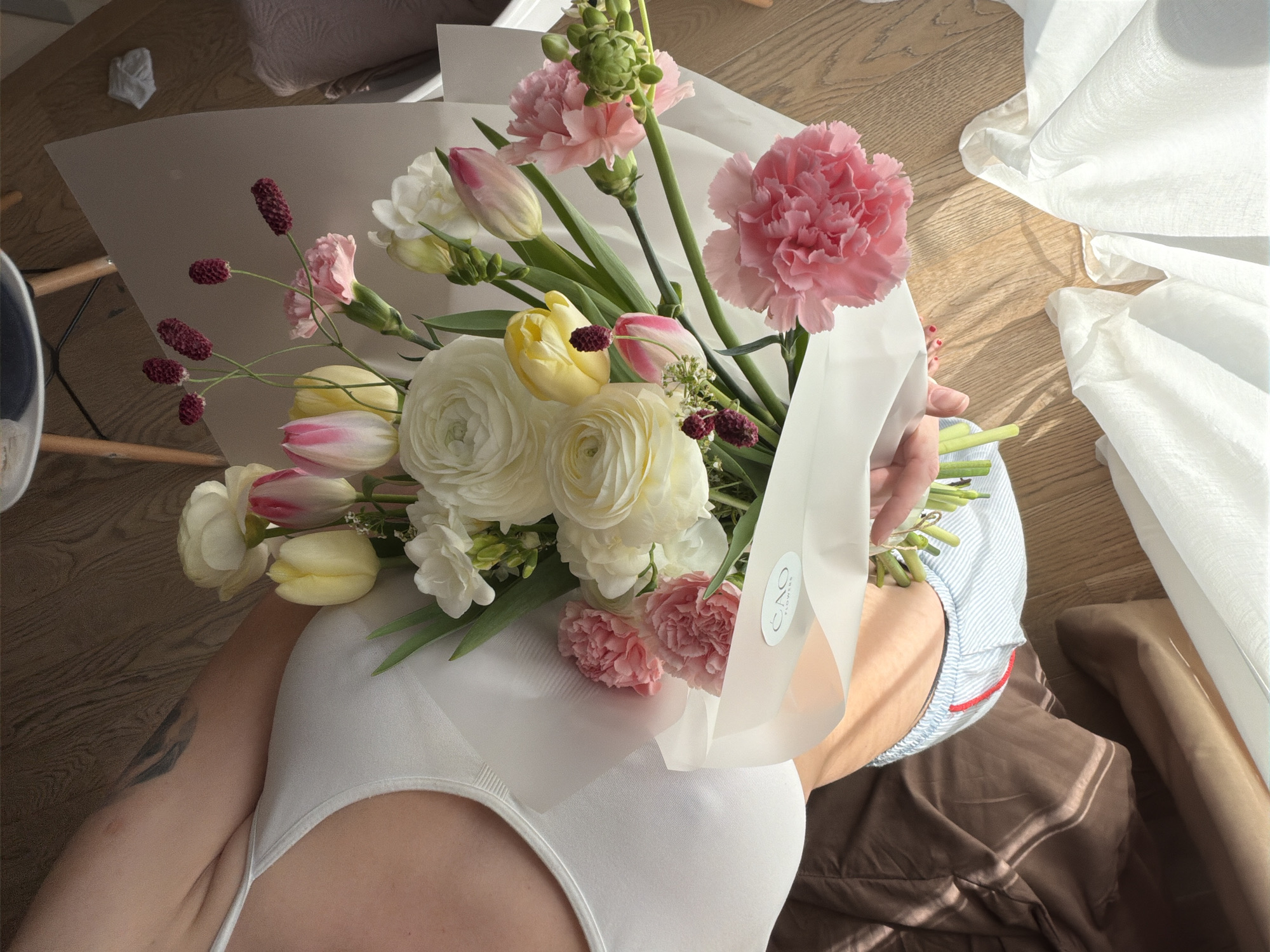 Woman with flowers, playful cat documented in Belgrade home