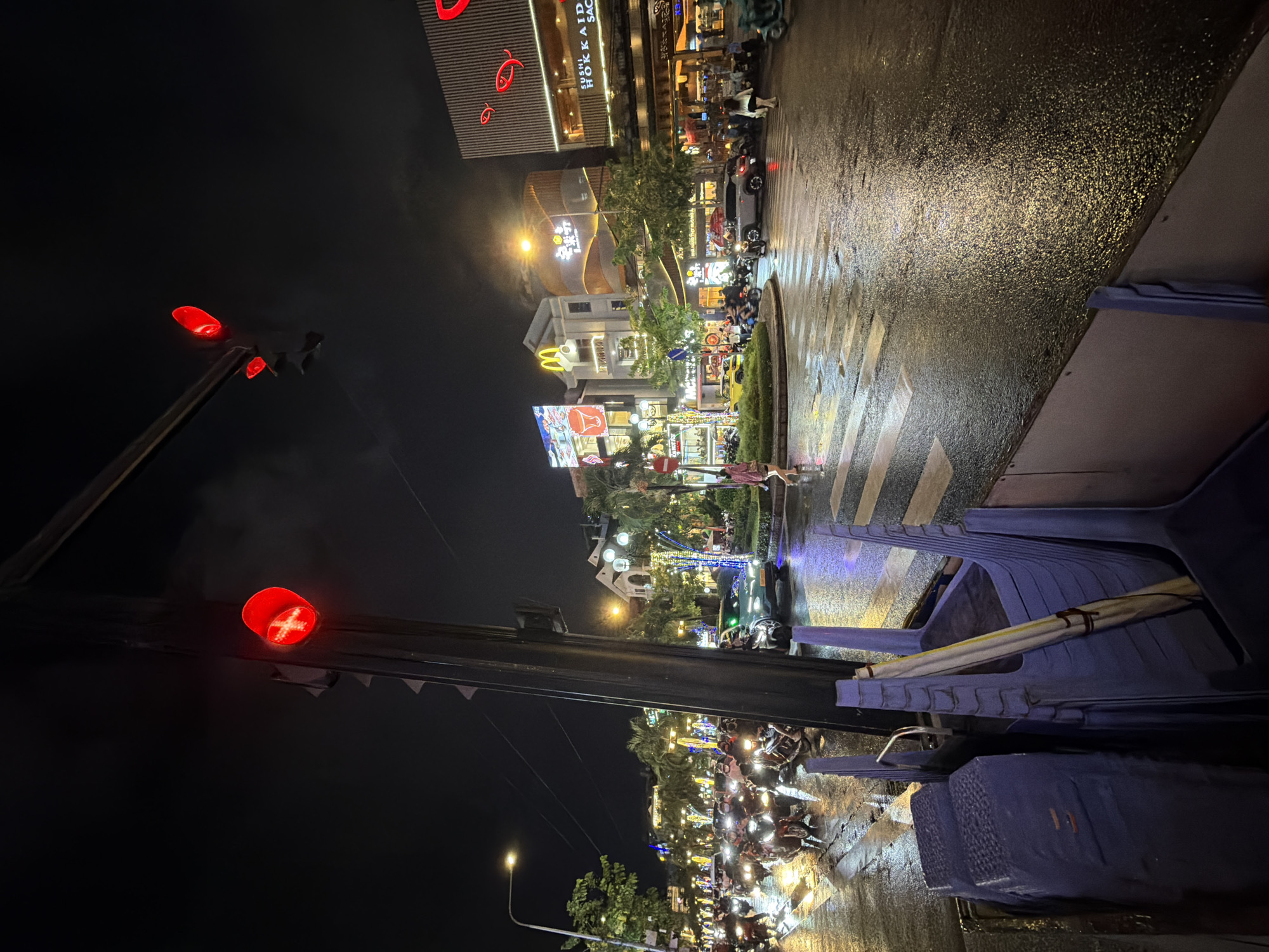 Rainy night street life documented in Thủ Đức City