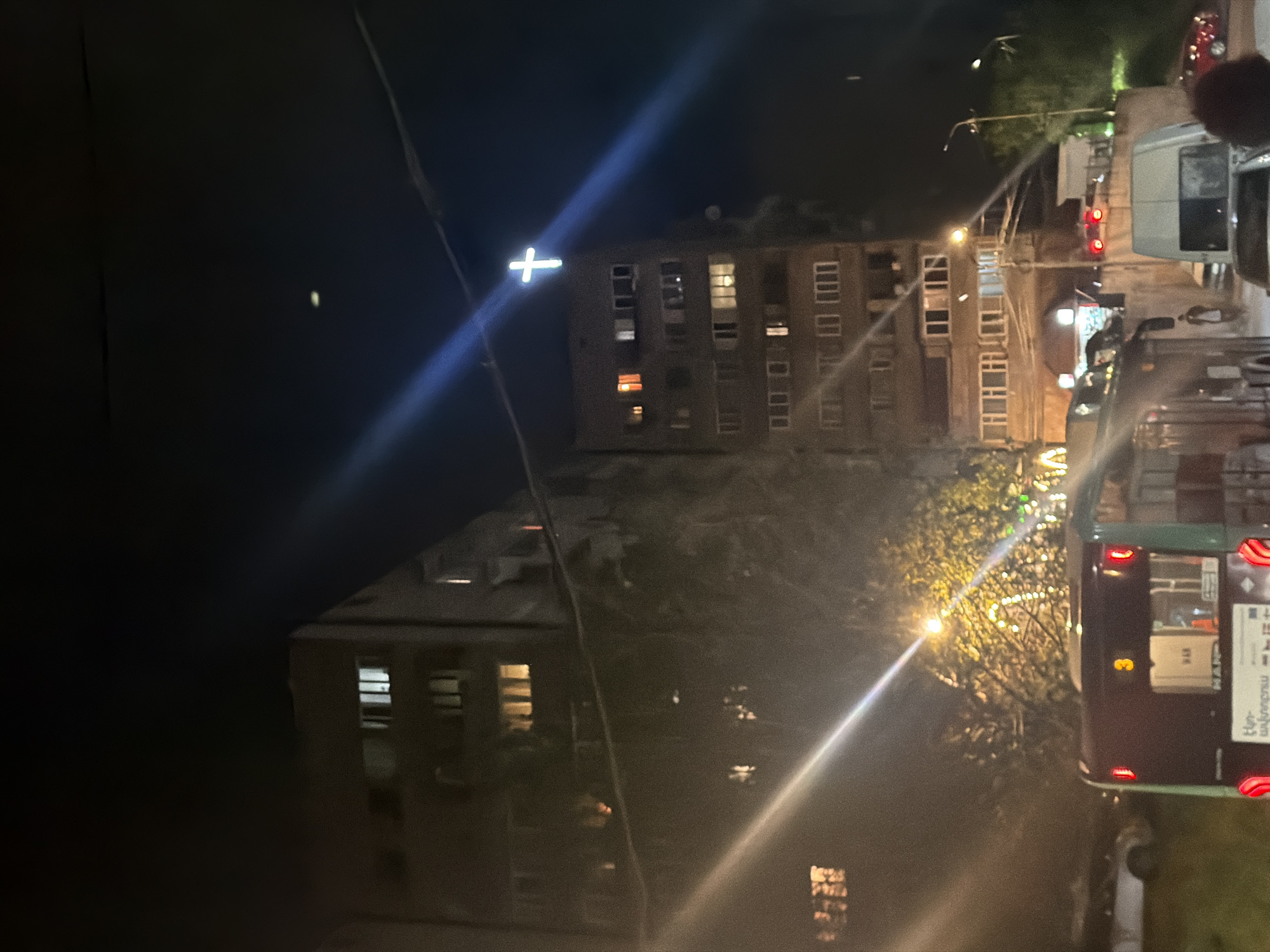 Illuminated cross atop building observed in nighttime Yerevan