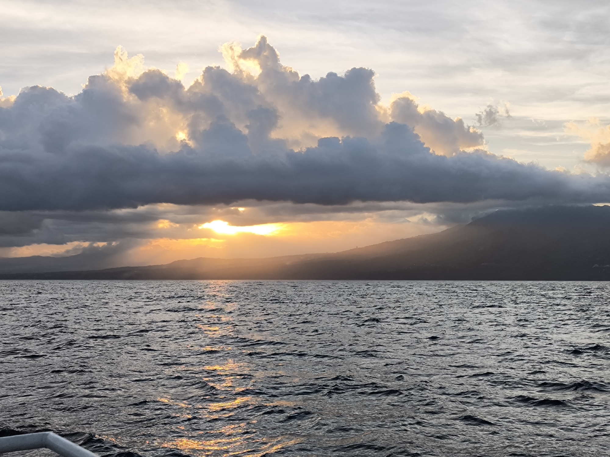 Dramatic sunrise captured over Indonesian waters amid cloudy skies