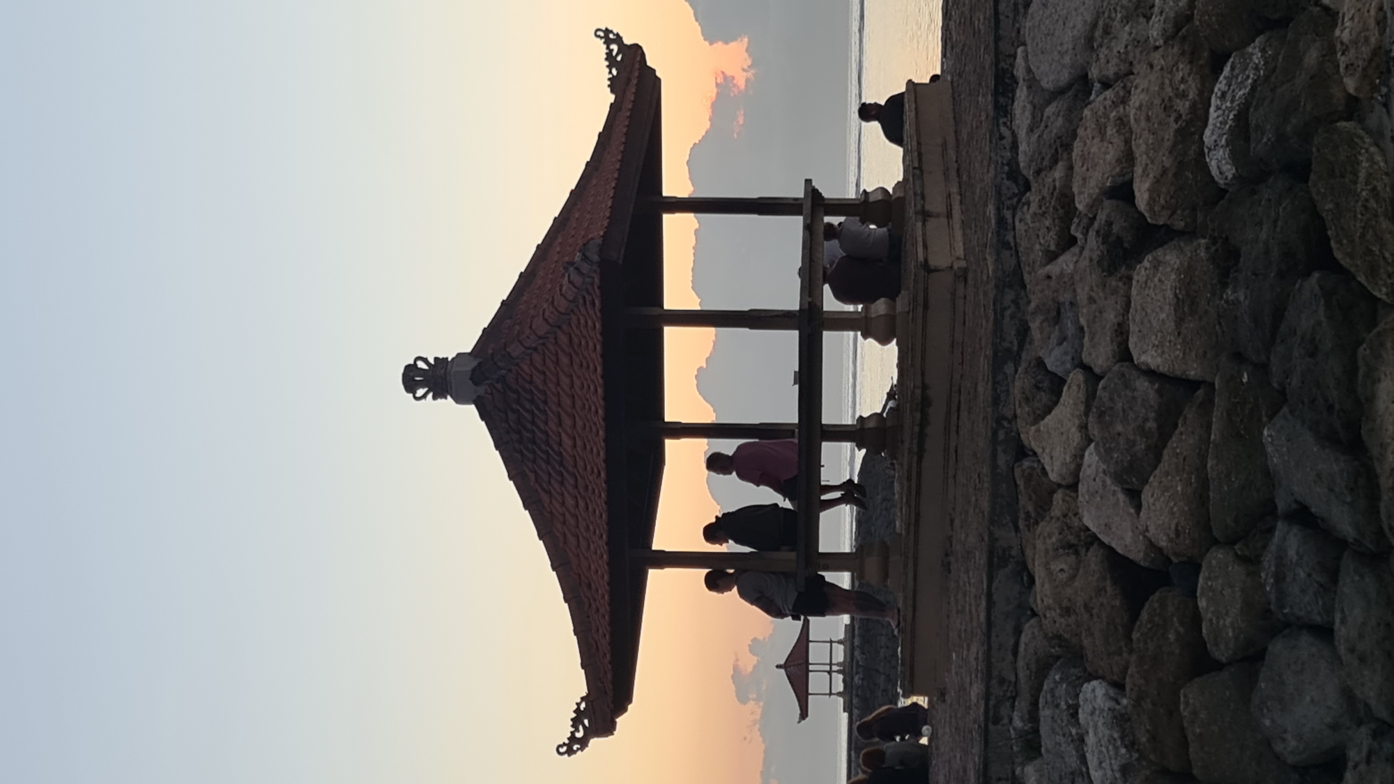 Sanur Beach at golden hour, boats, rocks, and quiet shoreline moments