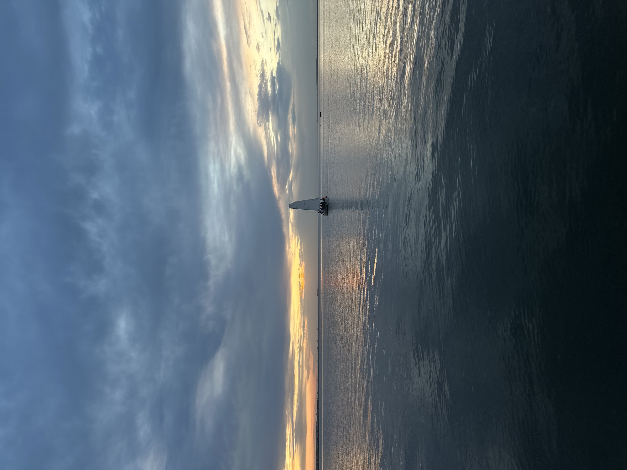 Evening boaters captured on Lake Kopa during Kazakhstan sunset
