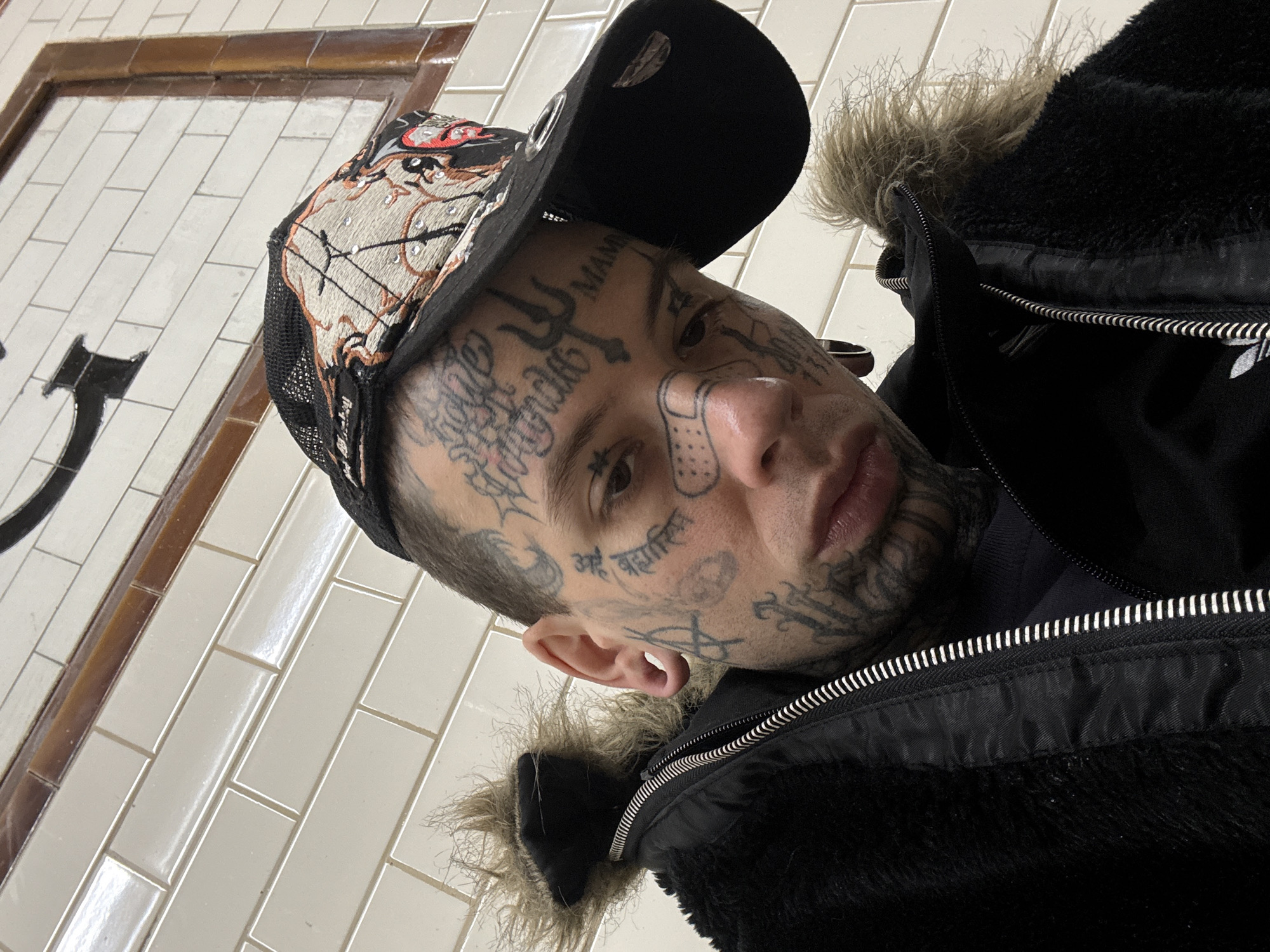 Close-up selfie with facial tattoos and fur-lined jacket, Buenos Aires