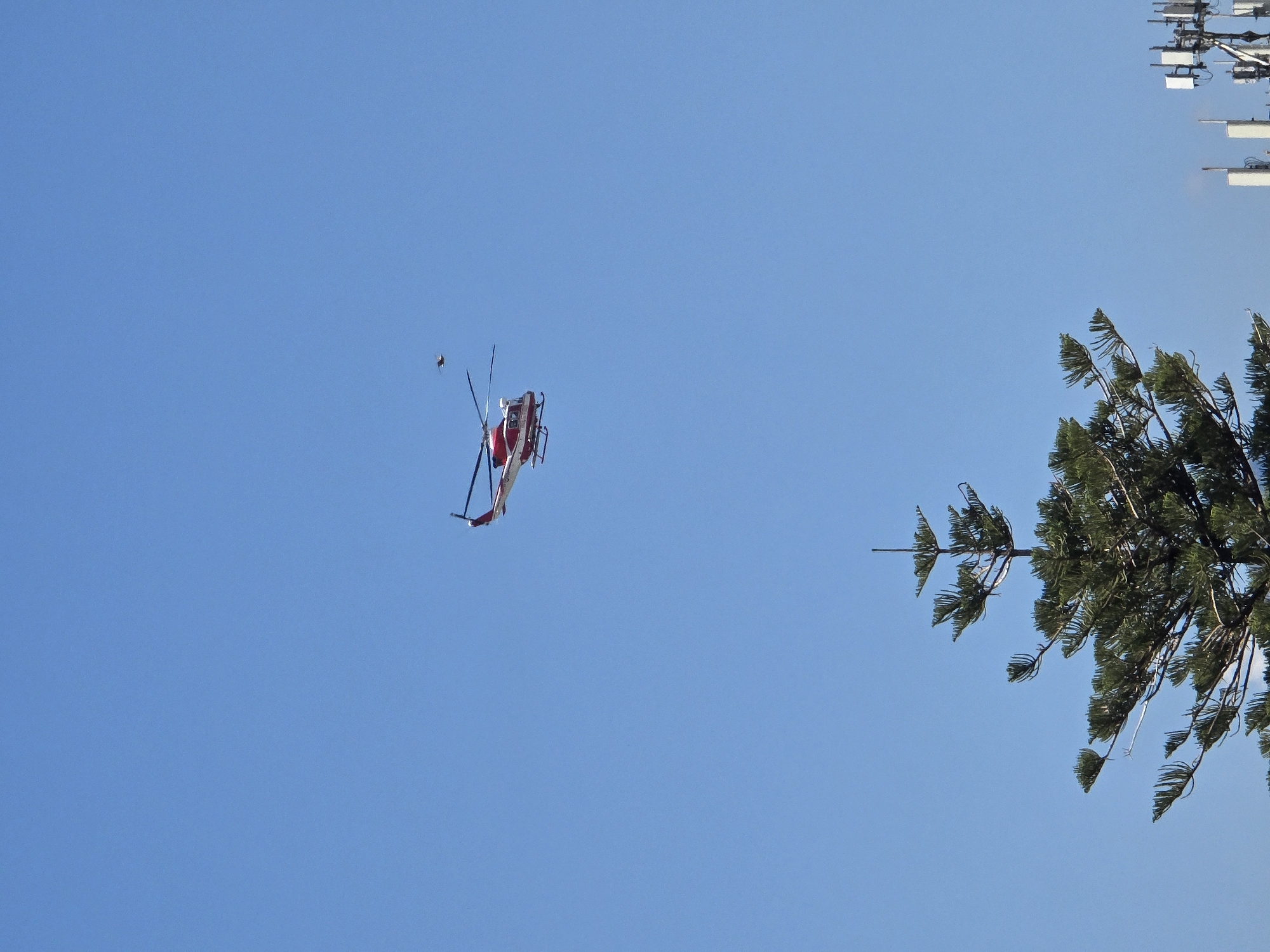 Red and white helicopter over Salerno on a clear morning