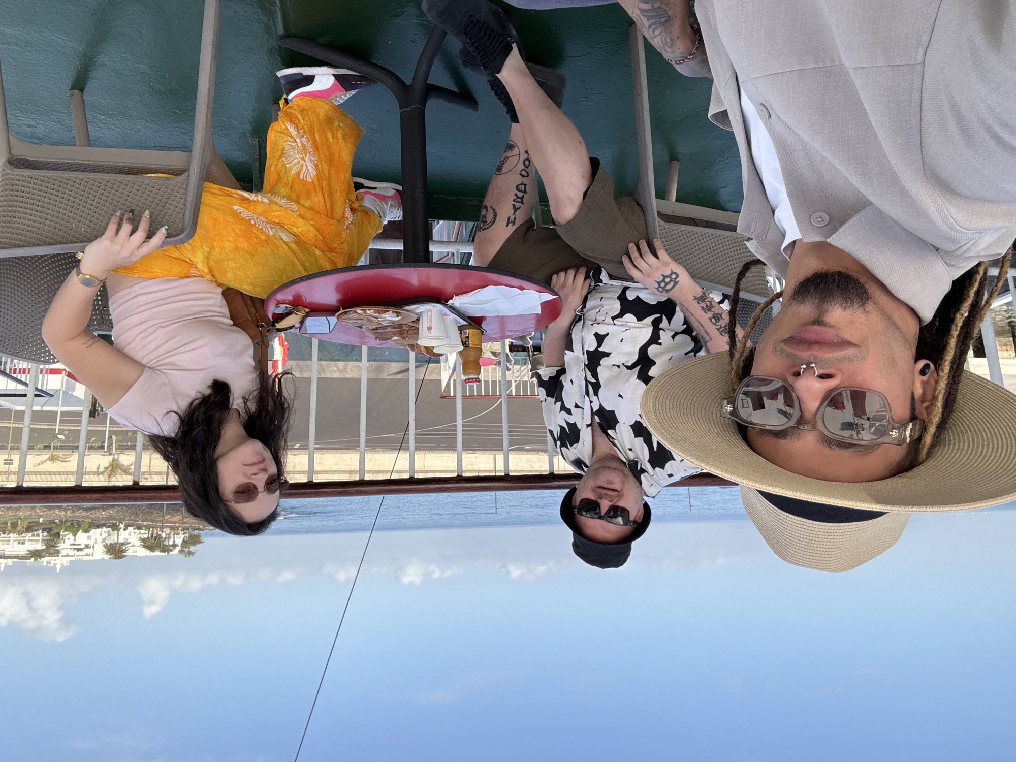 Three people relax on vessel deck near Yaiza, Canary Islands