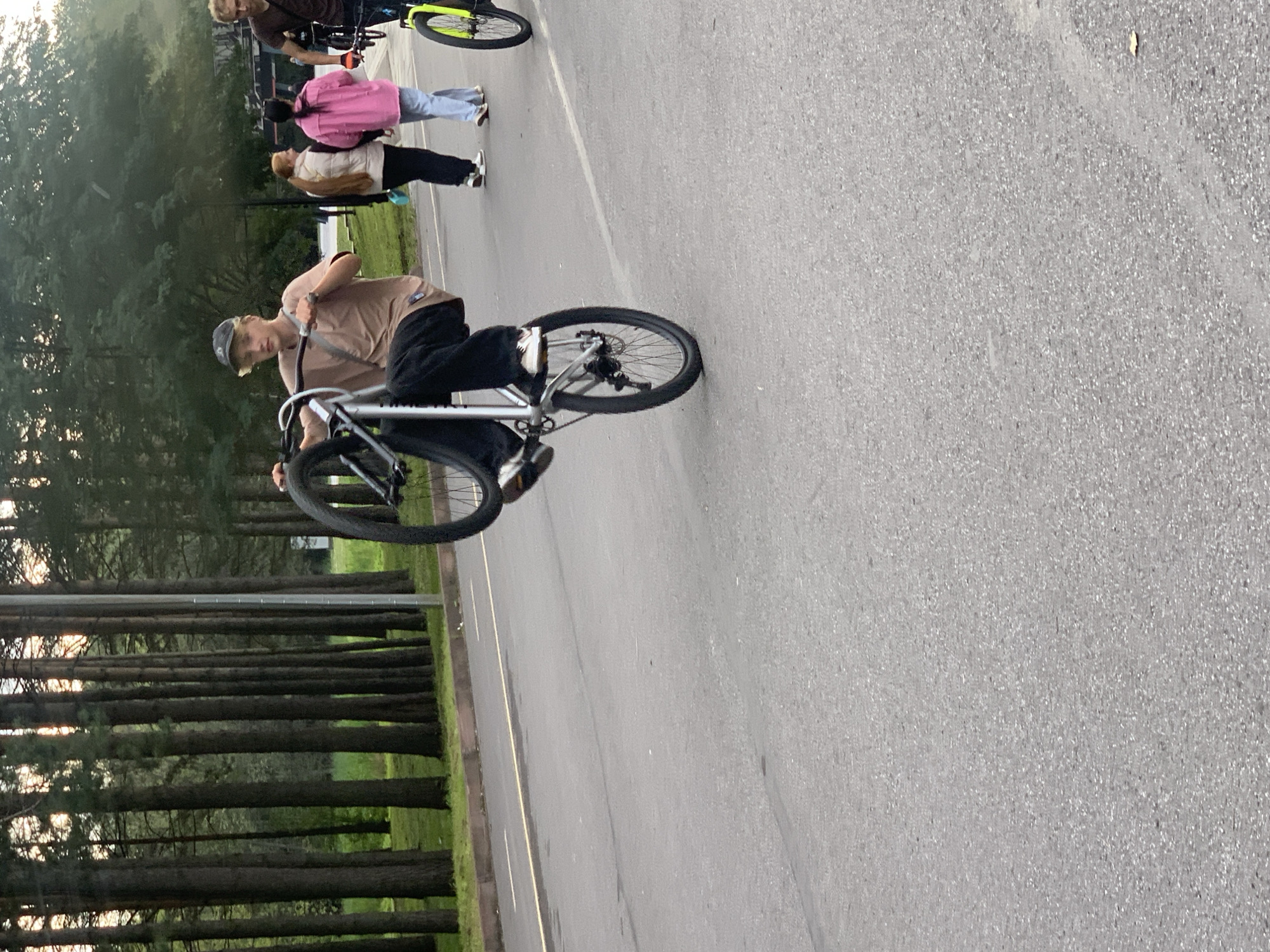 Cyclists hanging out in a Prokopyevsk park on a cloudy afternoon.