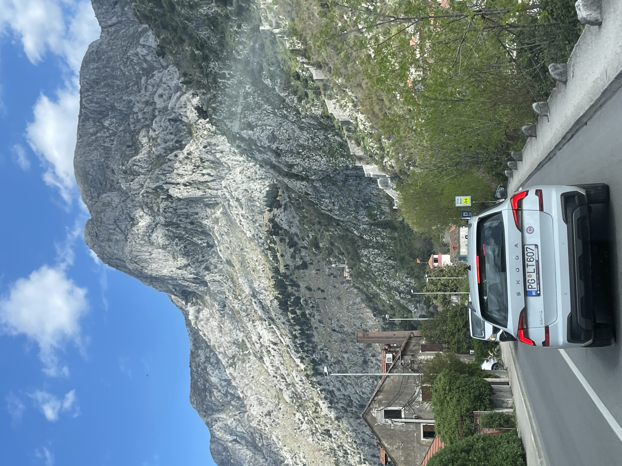 White Skoda spotted in Škaljari against mountain backdrop