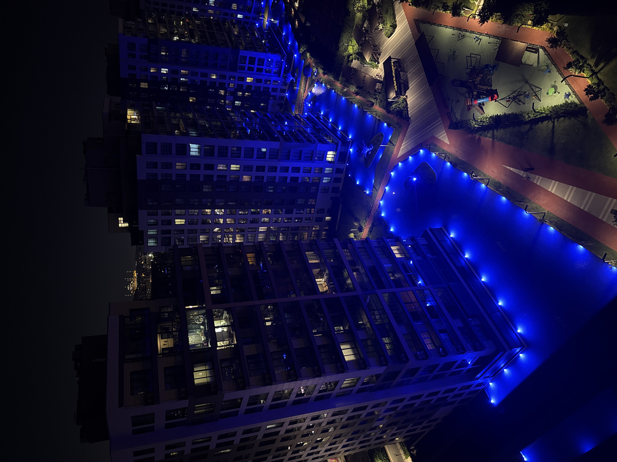 Ümraniye at night: residential towers and a lit mosque from above