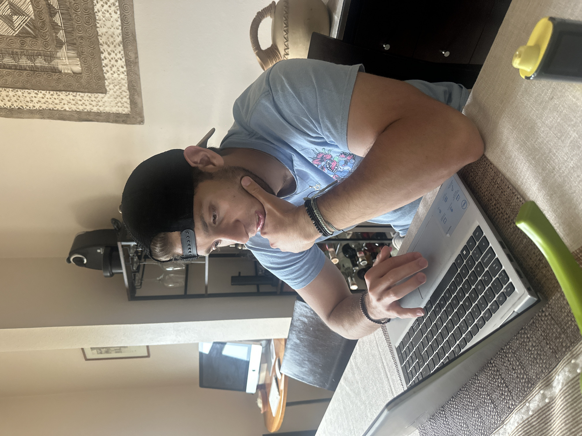 Person works on laptop while eating soup in Mexico