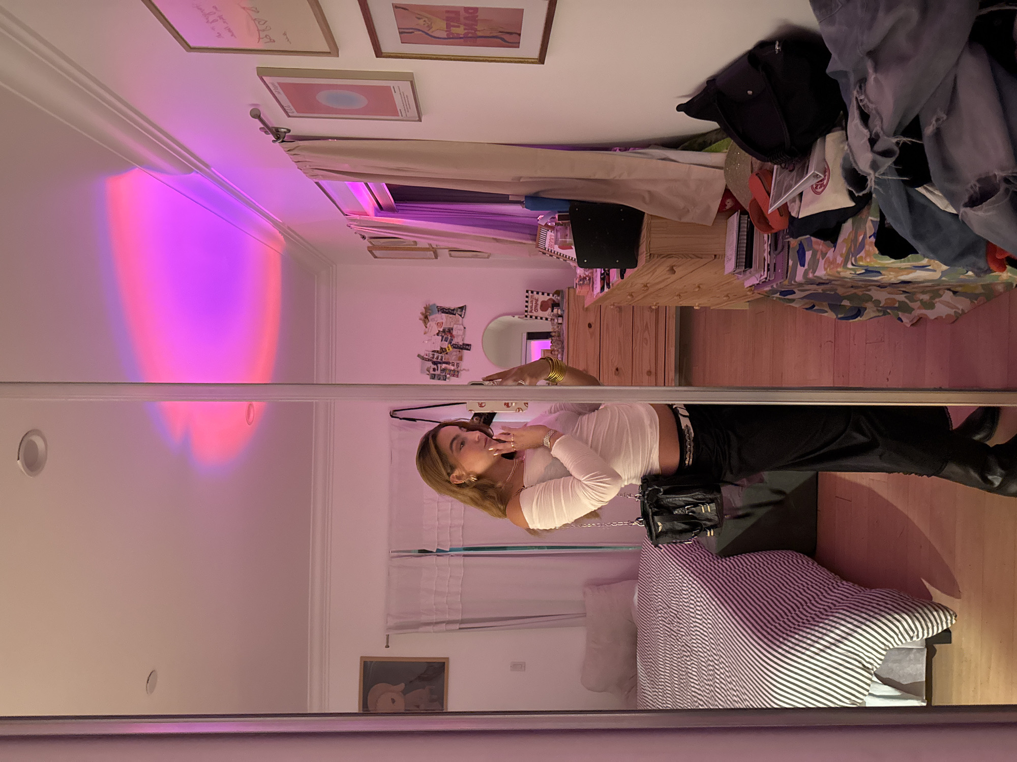 Mirror selfie in LA bedroom, white top and black boots