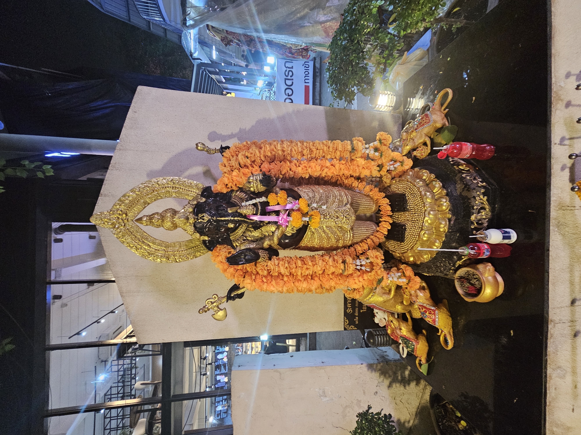 Bangkok hotel district at night: fountains, shrines, and city streets