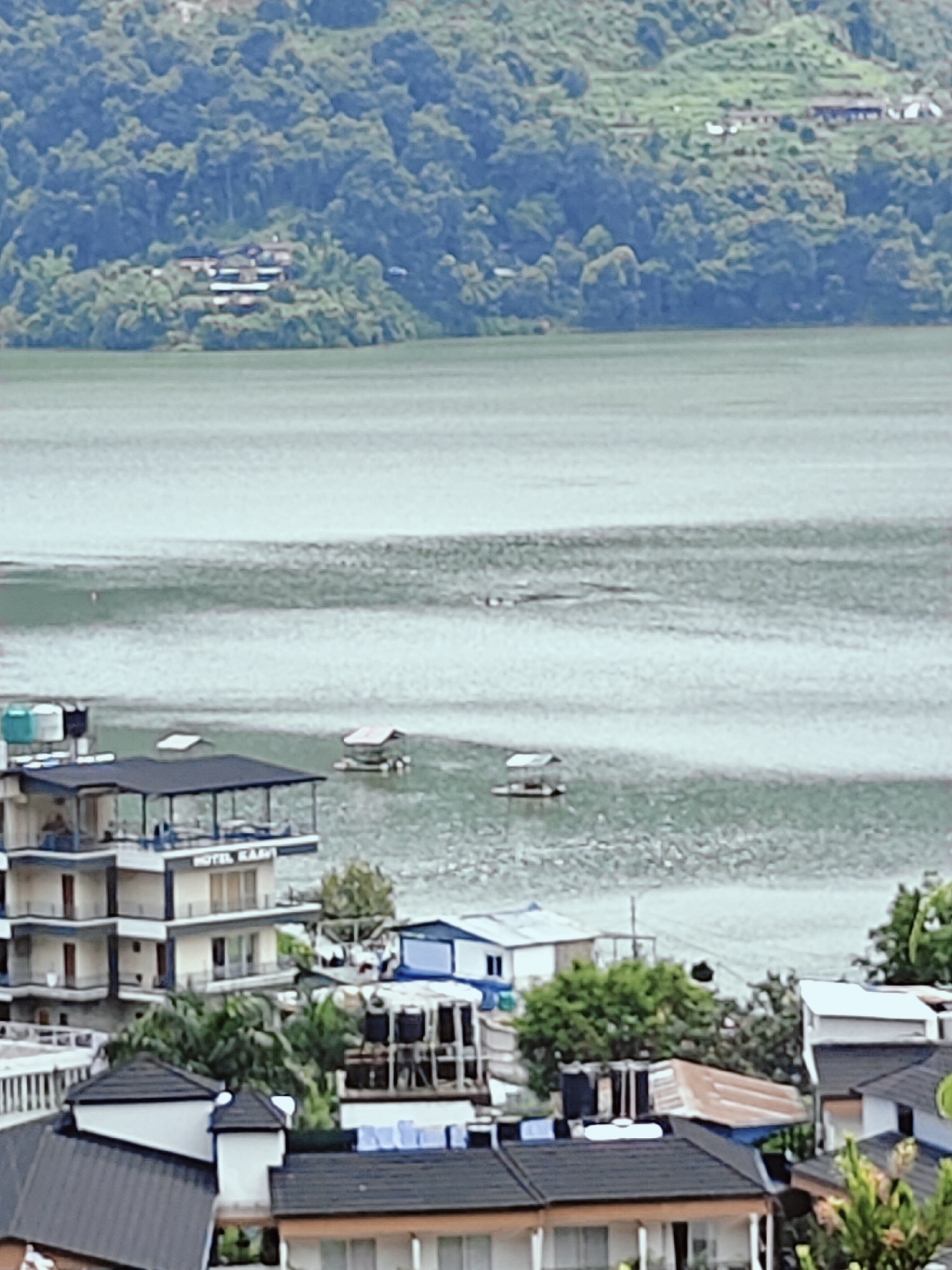 Phewa Lake shoreline in Pokhara on a cloudy morning
