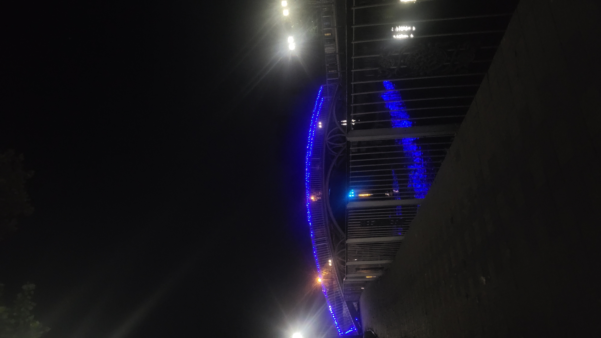 Colorful nighttime lighting at a waterfront park or promenade
