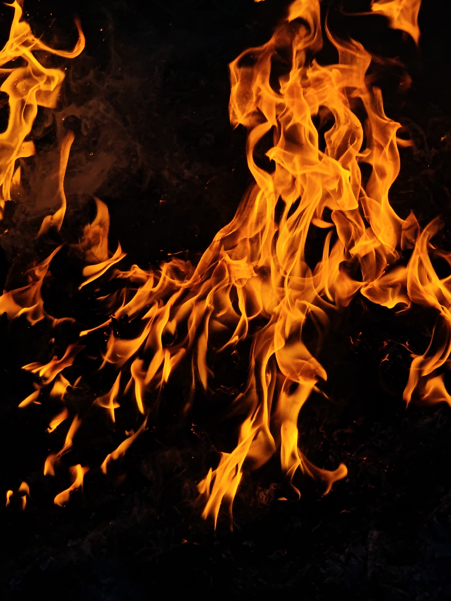 Small outdoor fire burns in Parkhomivka, Ukraine during evening