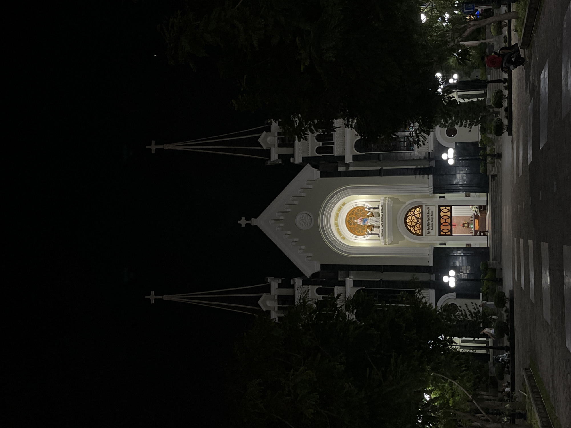 Nha Trang at night: cathedral spires, lit trees, and street life