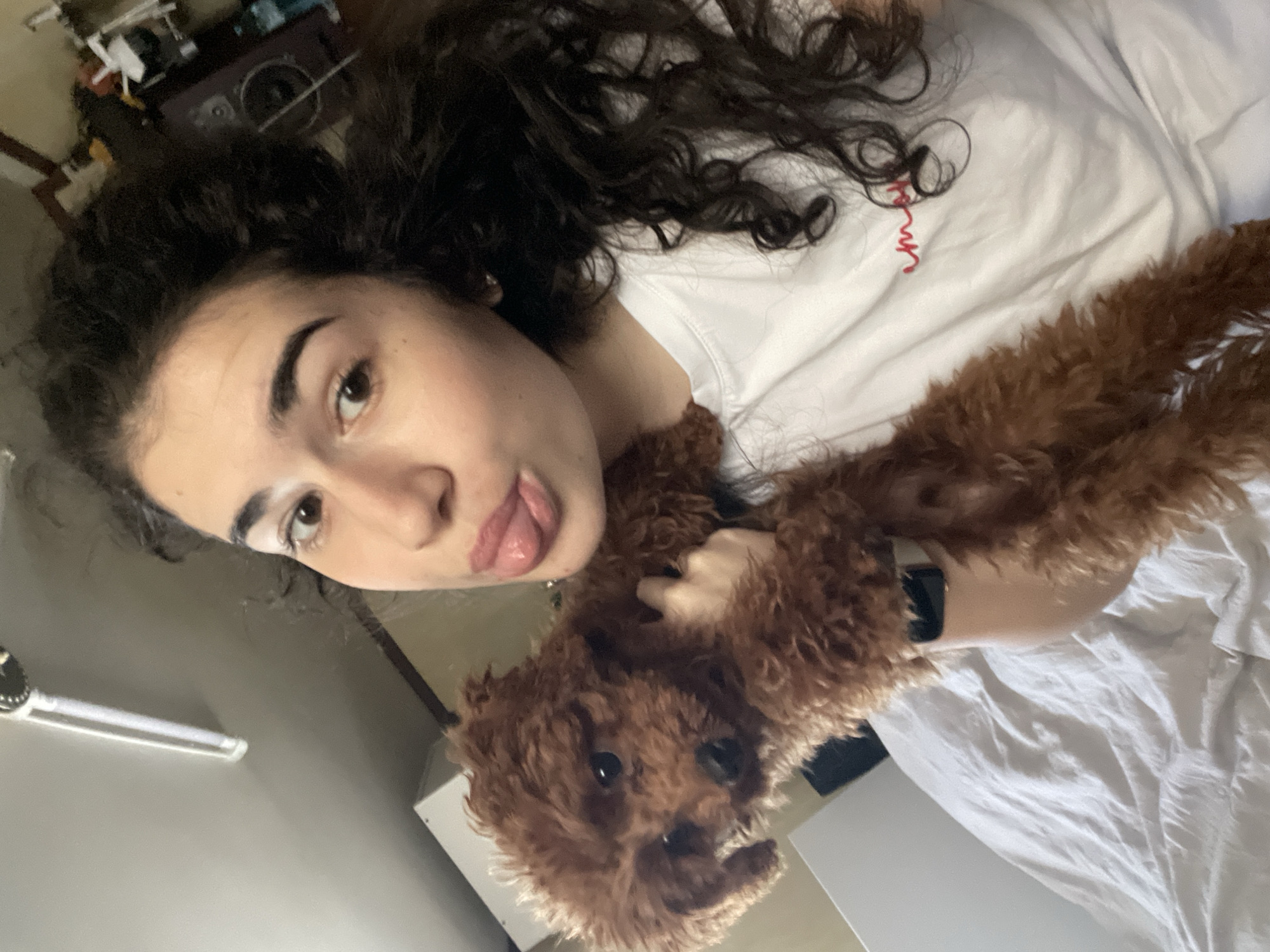 Woman poses playfully with poodle in Sofia apartment