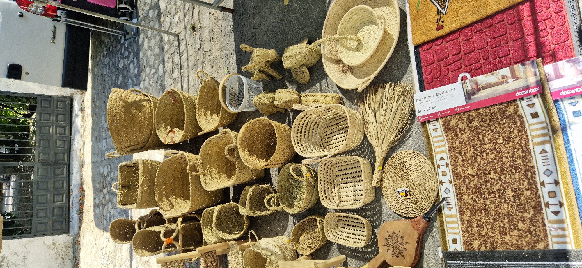 Street market in Navaluenga selling produce, clothes, and trinkets