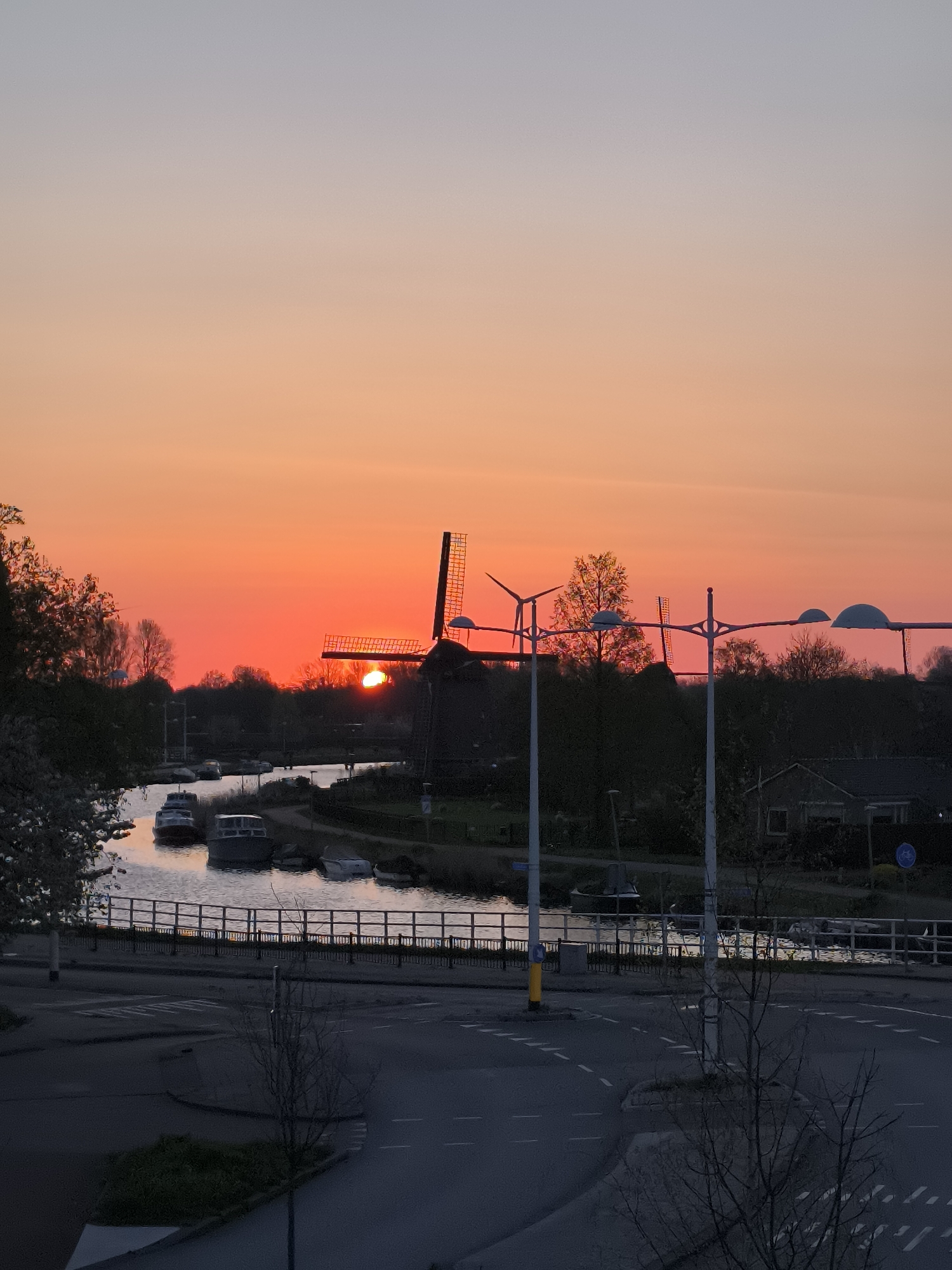 Vibrant sunset documented over Alkmaar canal in Netherlands