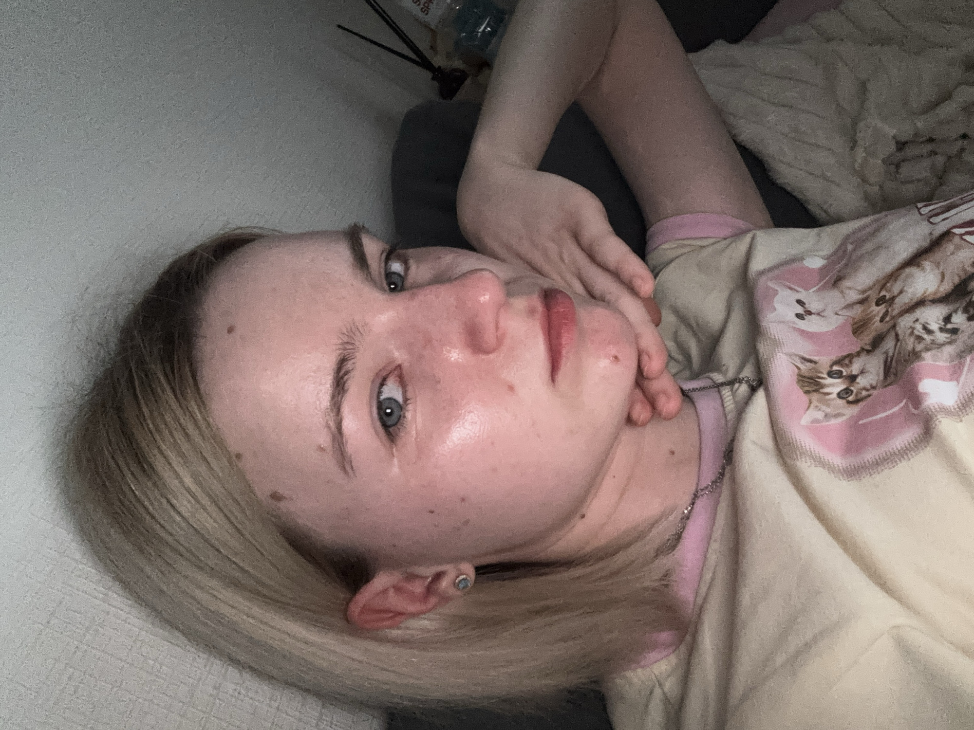 Person resting indoors wearing 'LOVELY LIFE' shirt captured close-up