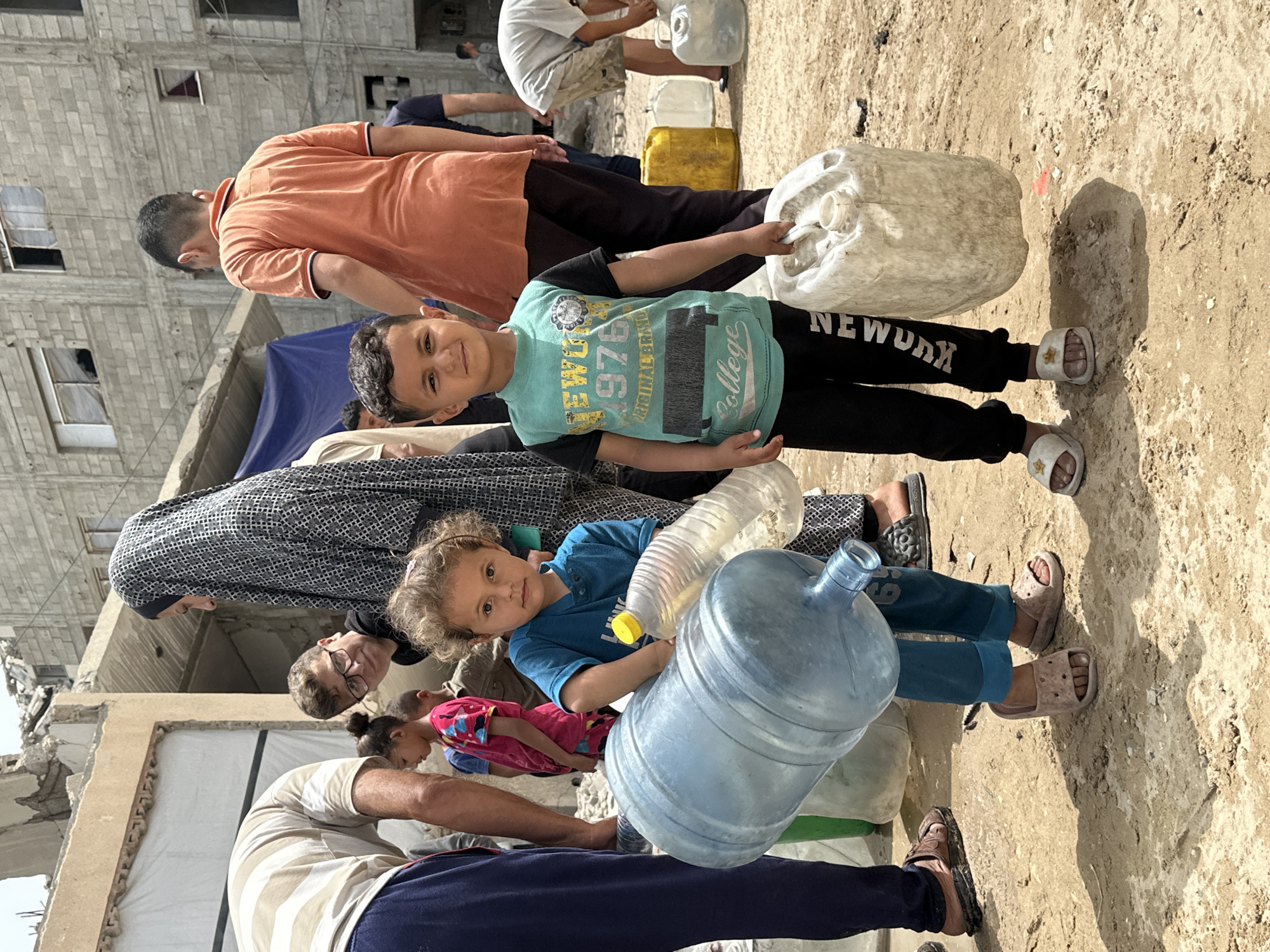 Children carry water, play amid debris in Gaza