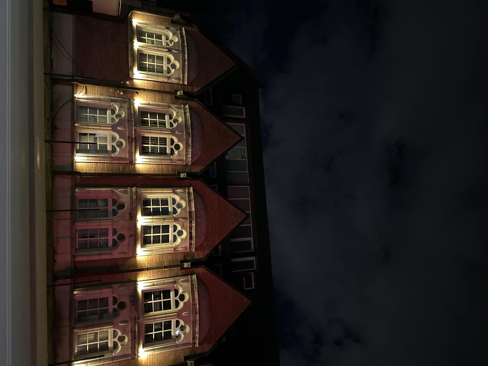 Ornate brick building with lit windows photographed in Sofia