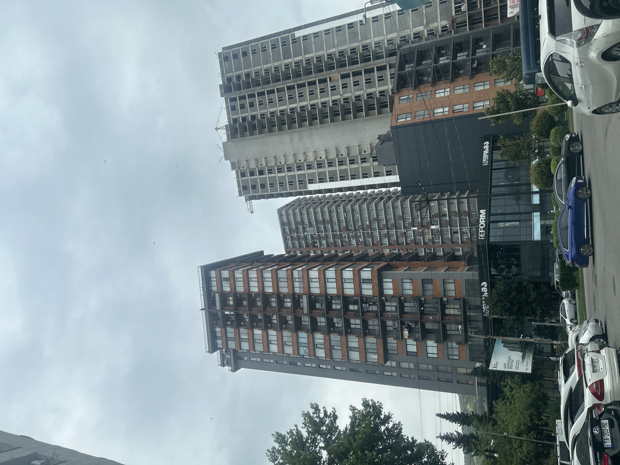 Tbilisi street shows residential towers and active construction site
