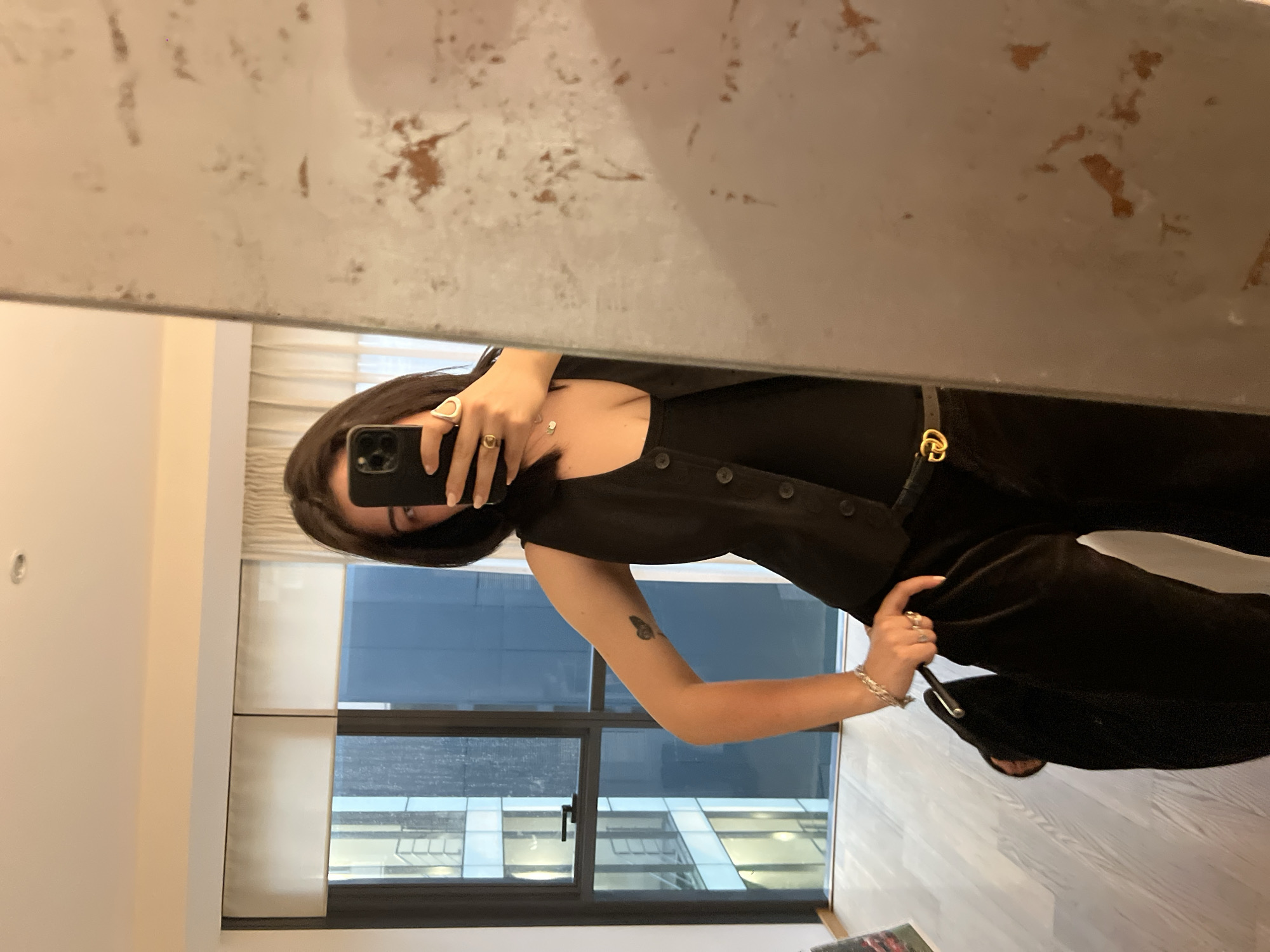 Mirror selfie in a Mexico City apartment with a garden view