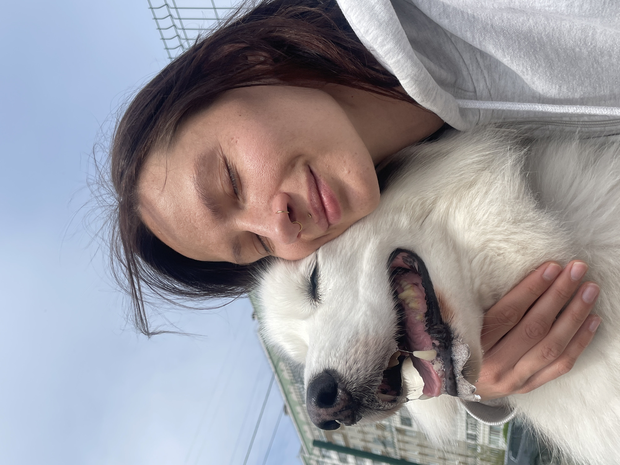 Woman embraces Husky dog in morning moment in Izhevsk