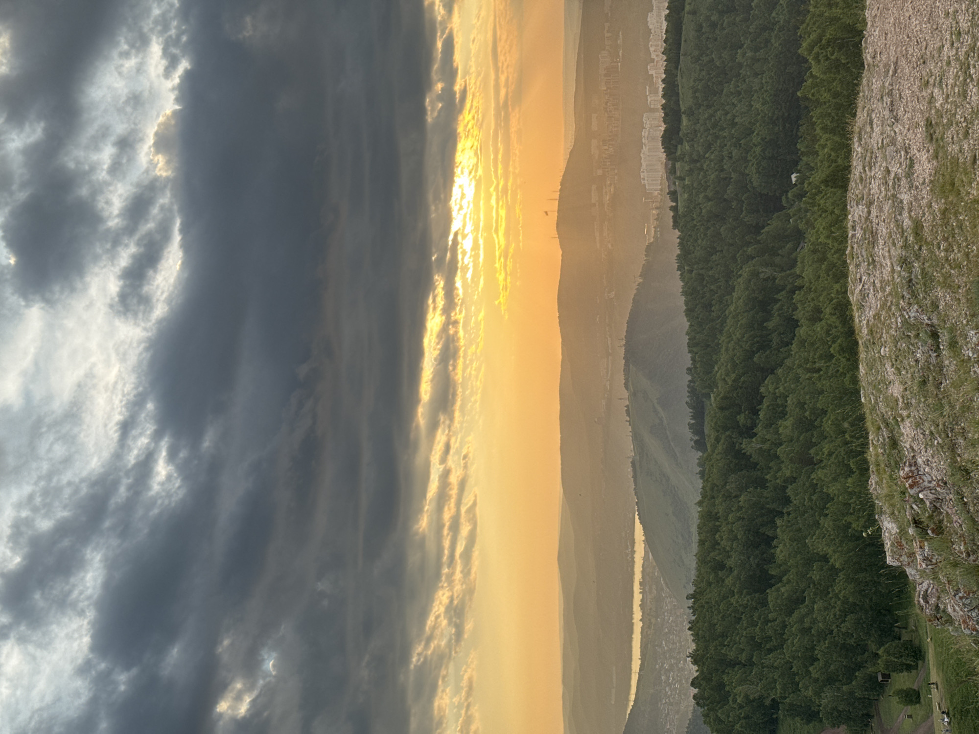 Hilltop sunset view over Krasnoyarsk under dramatic clouds