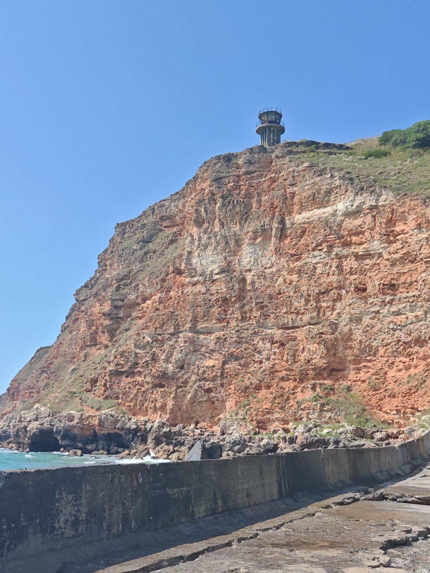 Lighthouse cliff and turquoise bay at Balgarevo's rocky coastline