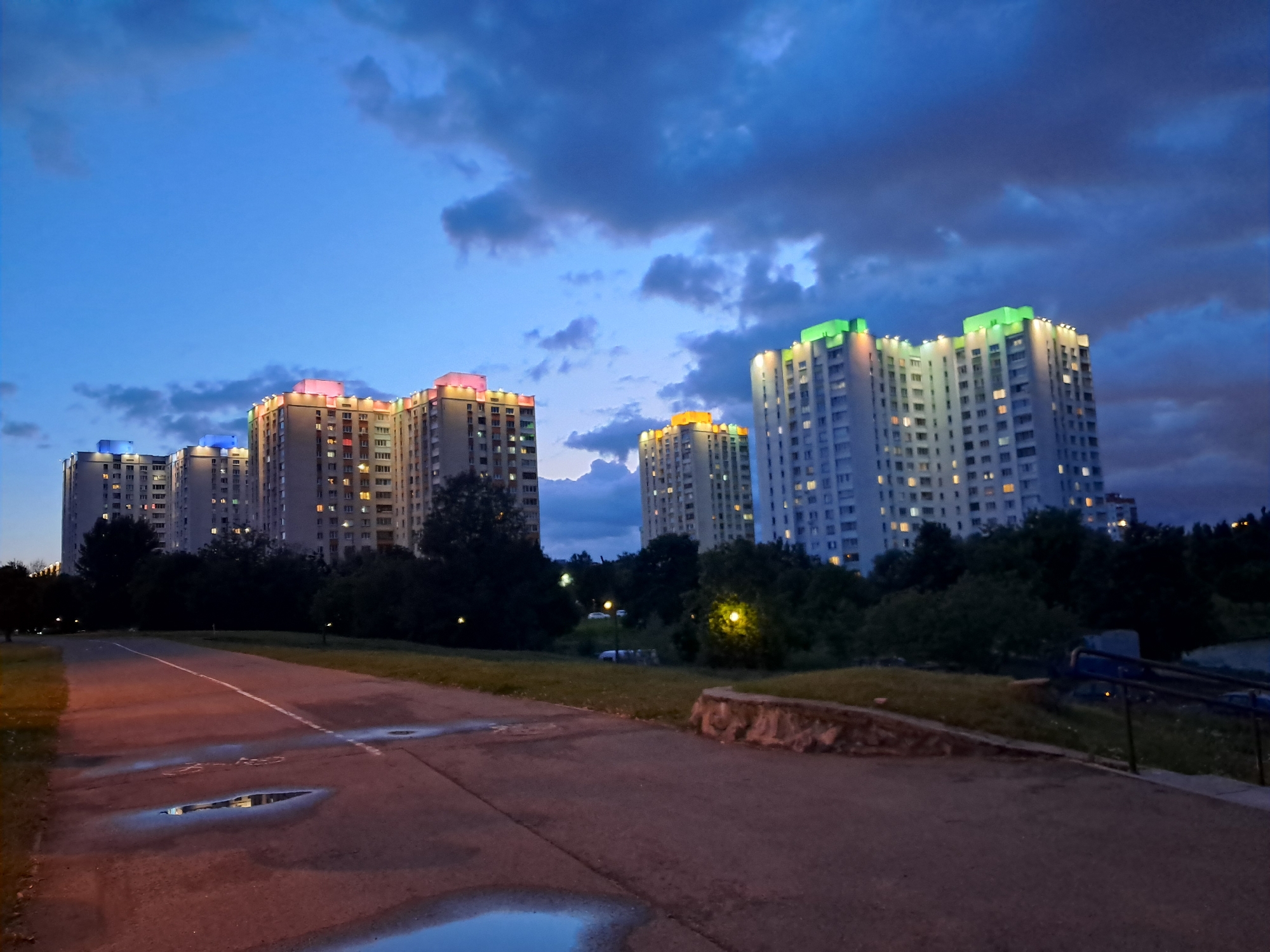 Minsk apartment towers glow with rooftop color at twilight