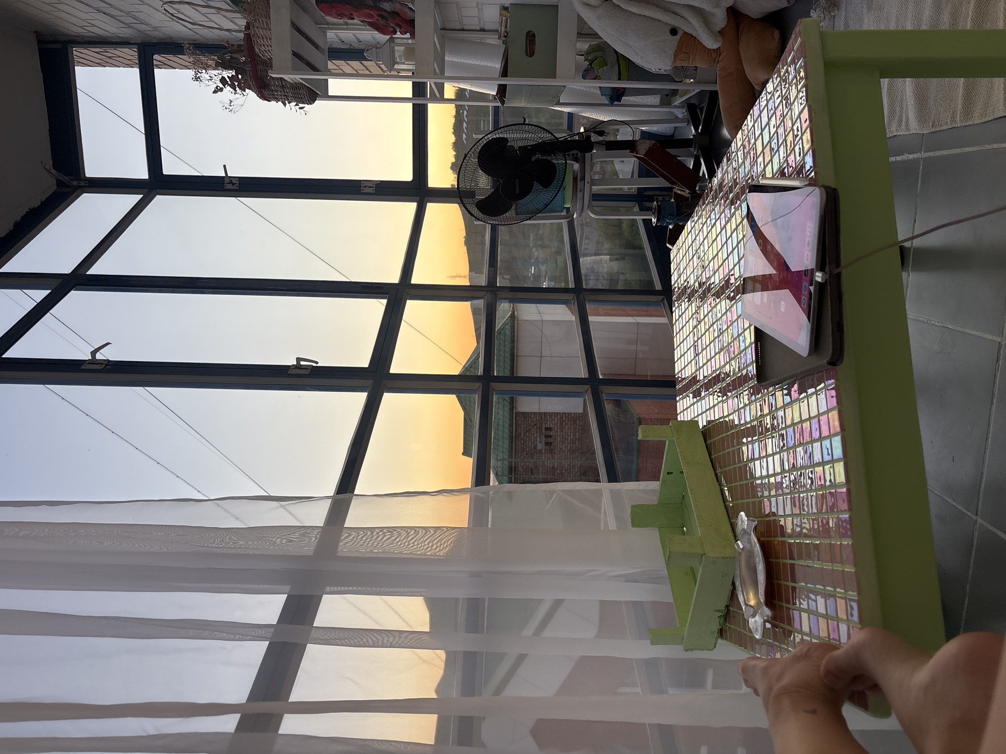 Friends toast with pink drinks in Krasnoyarsk sunroom