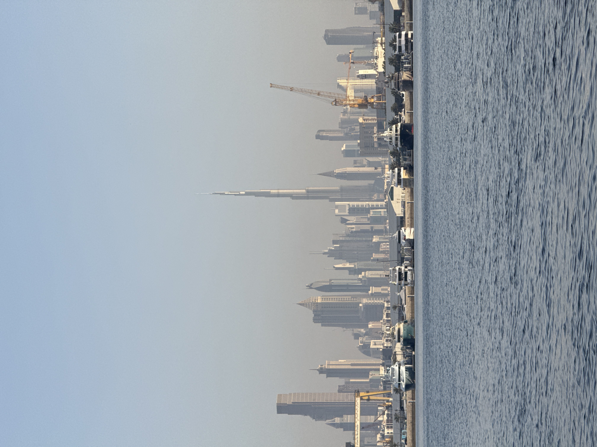Hazy Dubai skyline captured featuring Burj Khalifa and waterfront