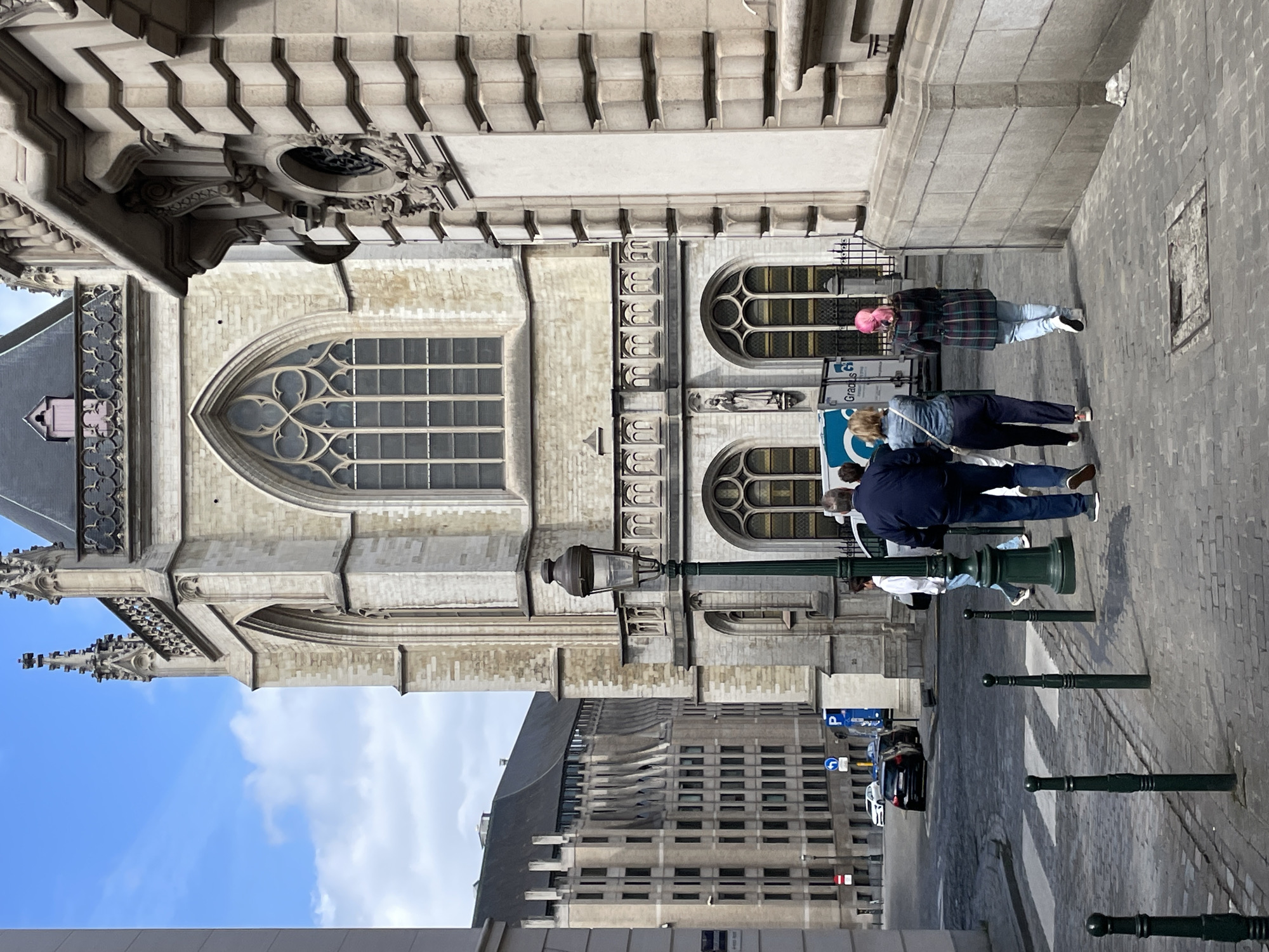Tourist documents Gothic cathedral and Brussels streetscapes during walking tour