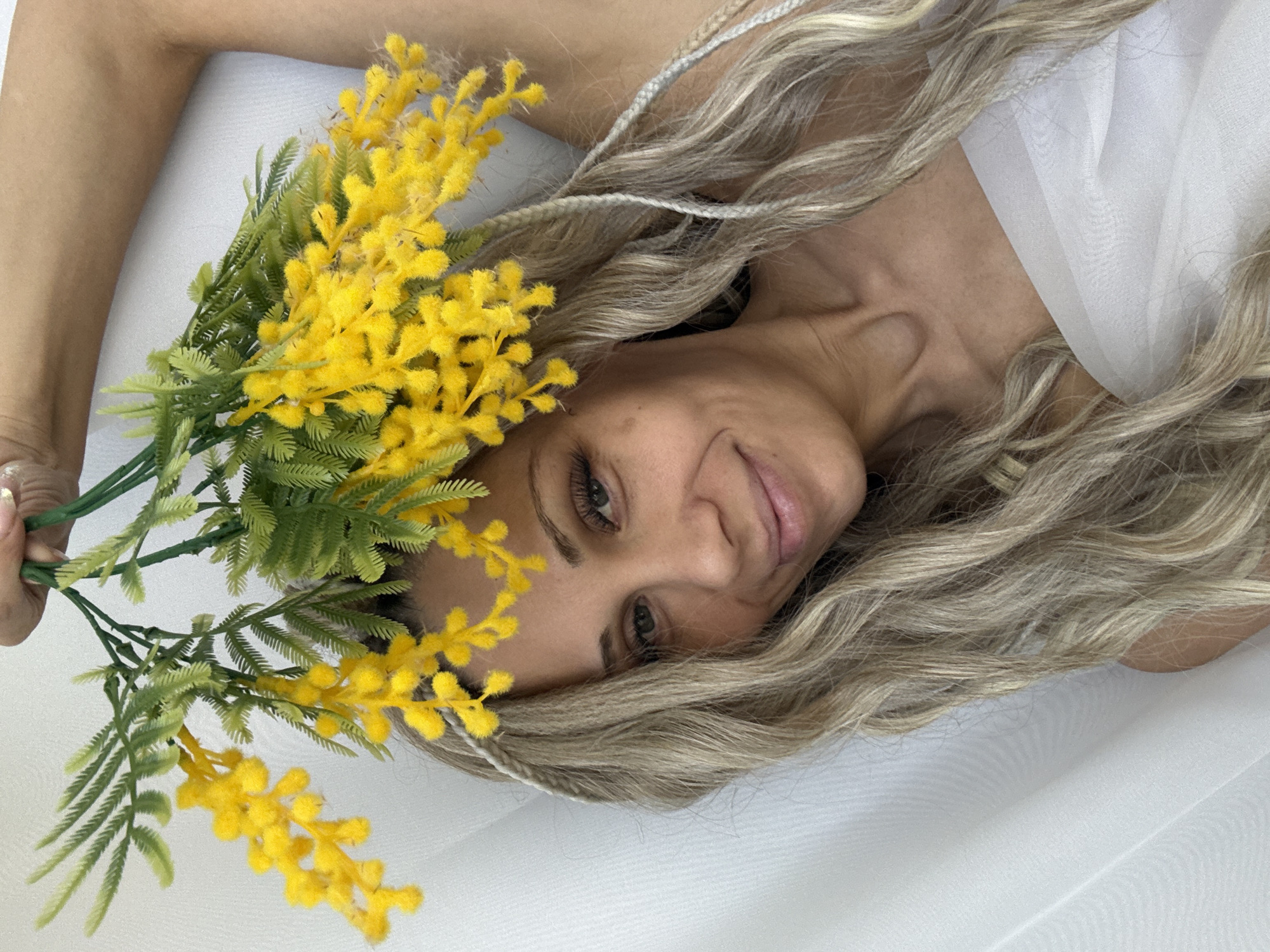 Woman photographed with mimosa flowers in Rusanovo studio session