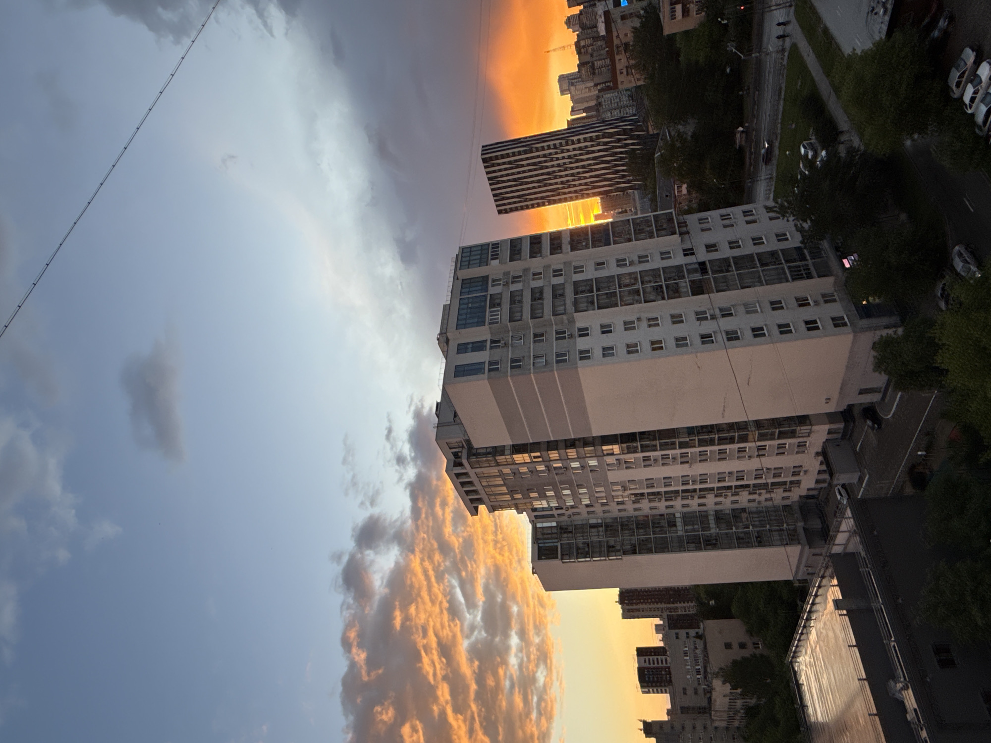 Dramatic sunset illuminates Yekaterinburg skyline amid cloudy evening