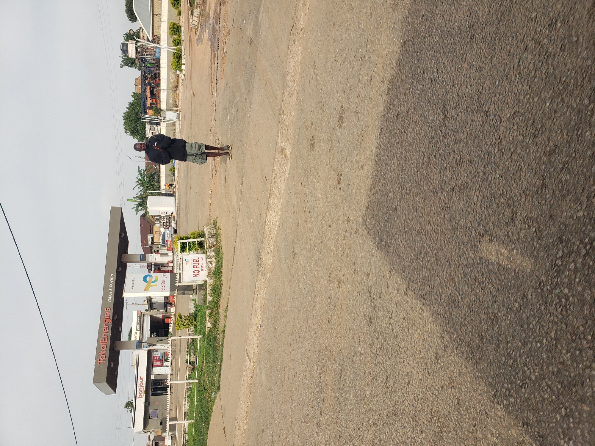 Morning street life documented around African gas station