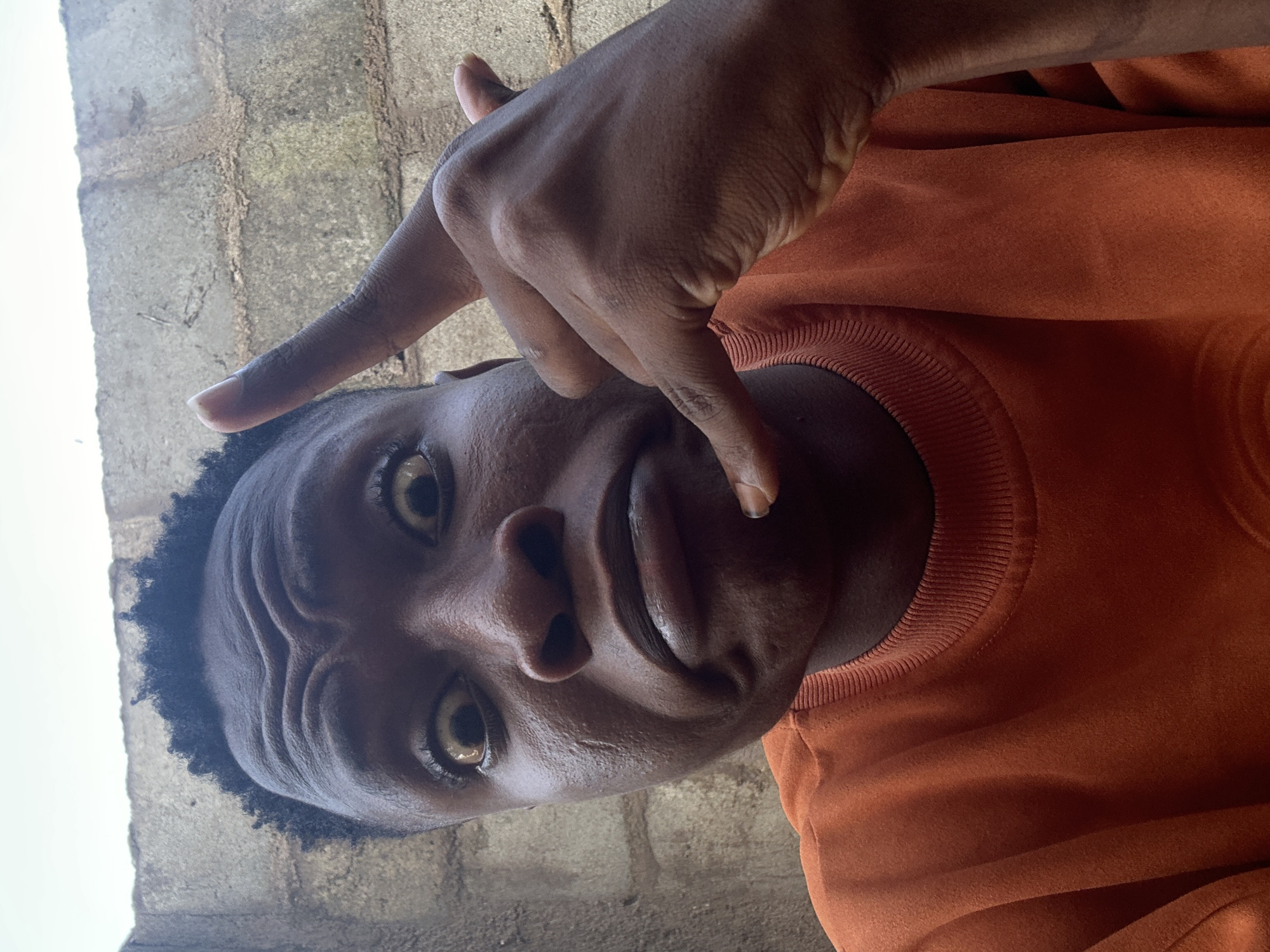 Afternoon selfie session in Ikorodu, orange sweatshirt, many moods