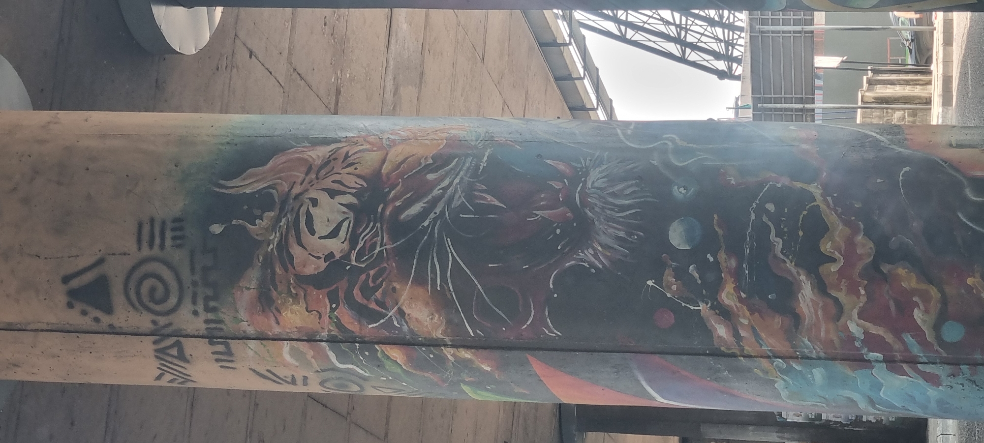 Vibrant graffiti art spotted on concrete infrastructure beam