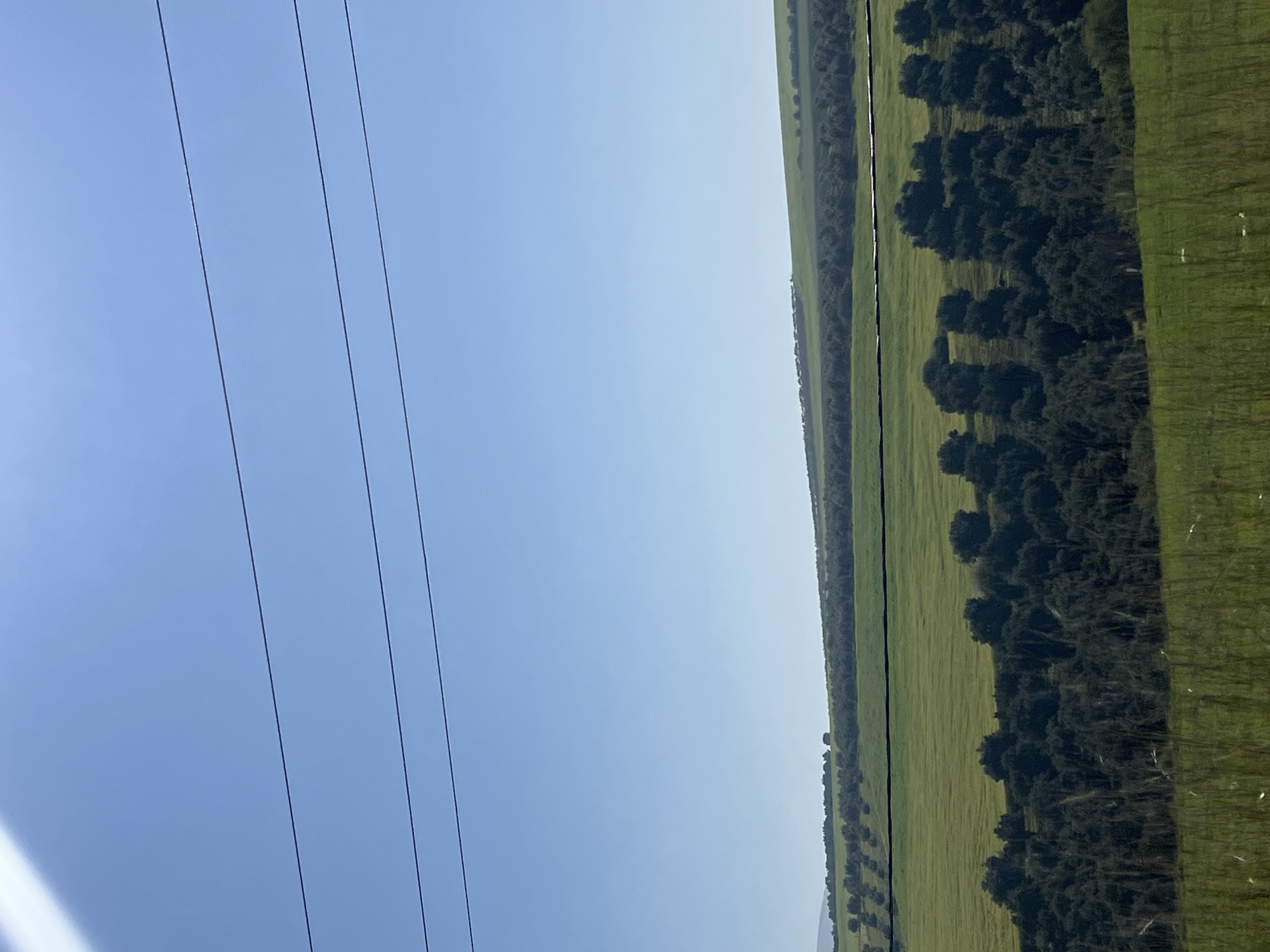 Power lines cross pale sky in rural Morocco